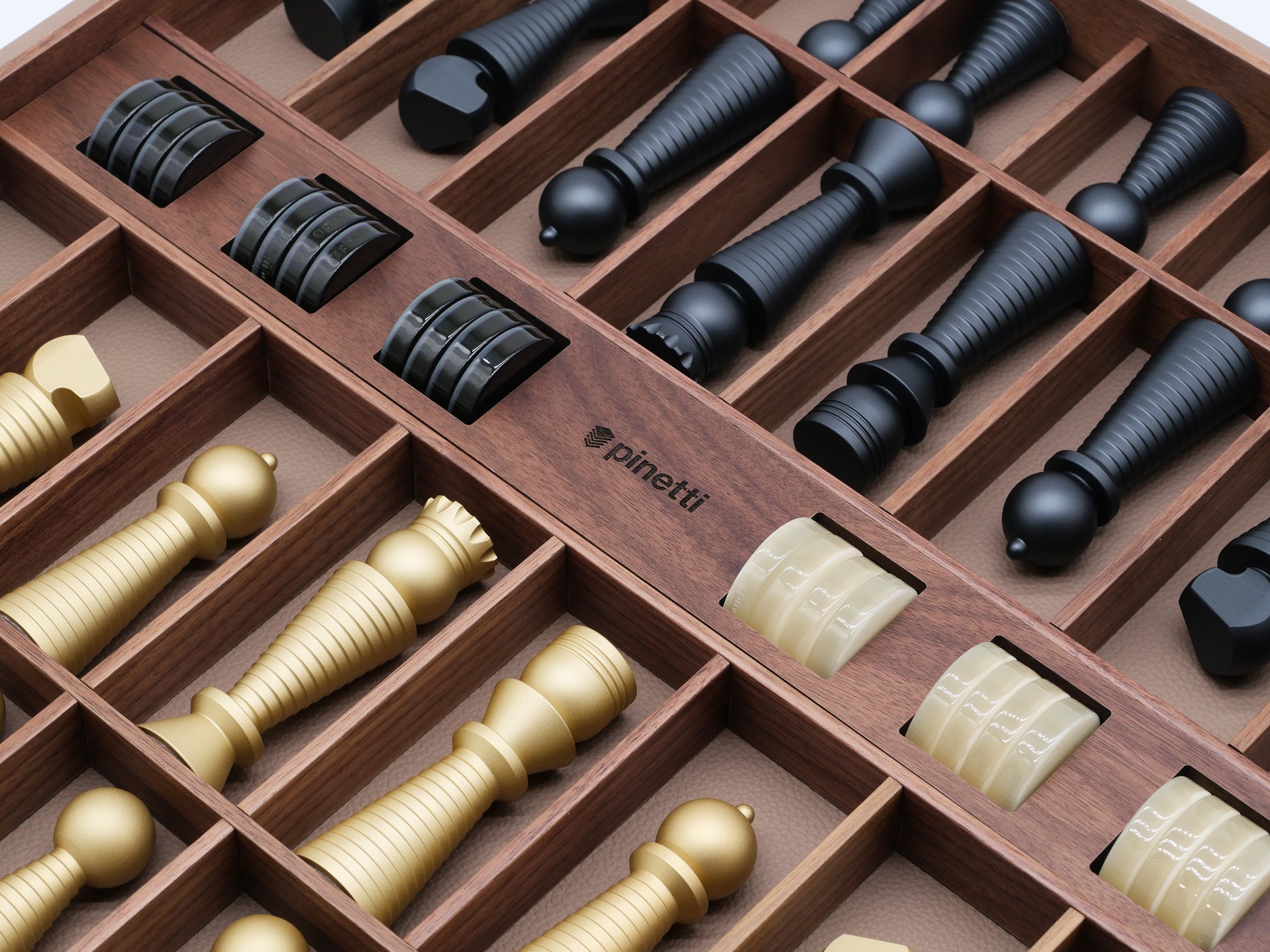 Open walnut chess and checkers storage box with black chess pieces neatly organized in compartments