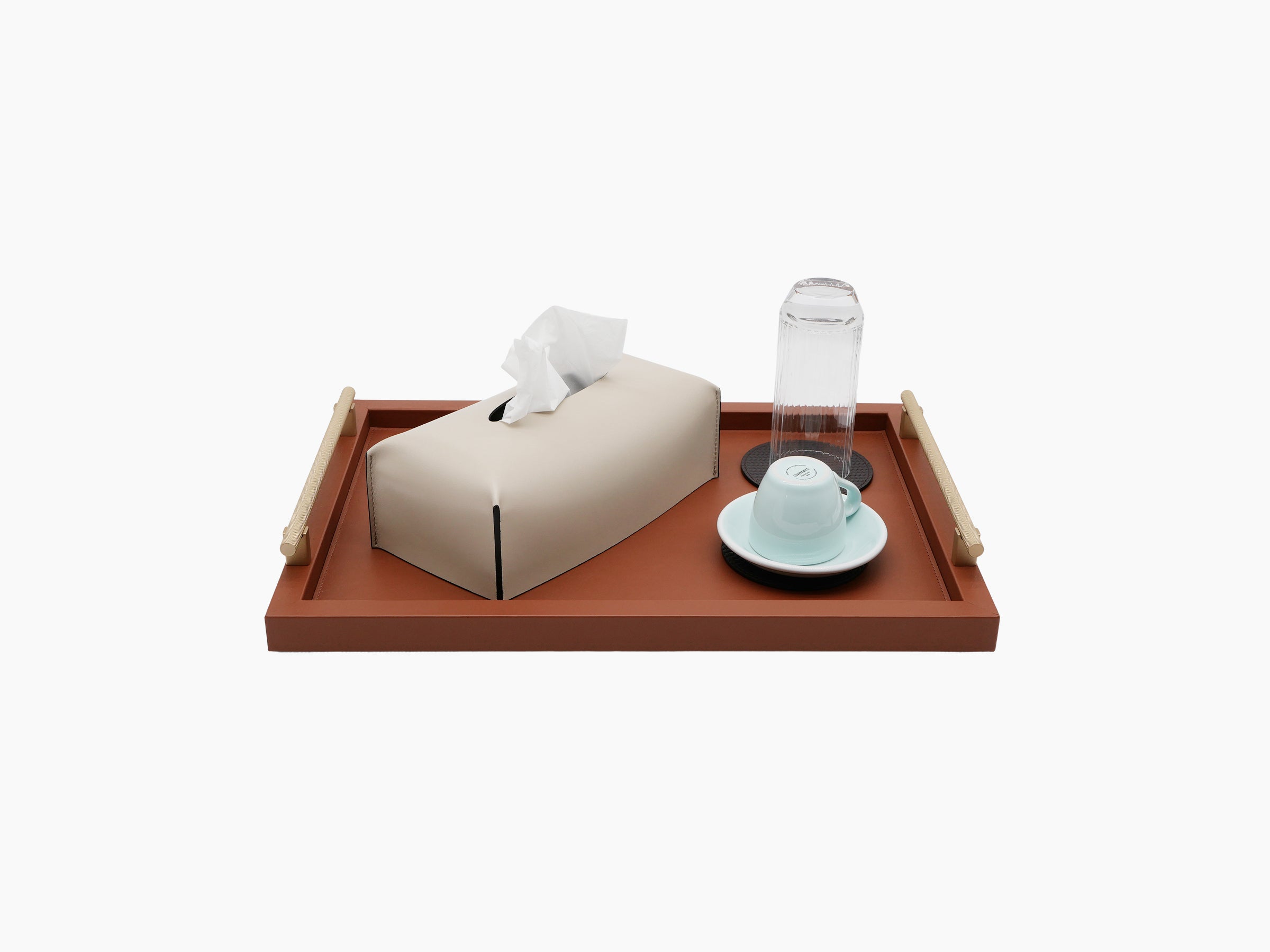 Dafne Medium Tray in a terracotta finish with light wood handles shown with a tissue box and glassware