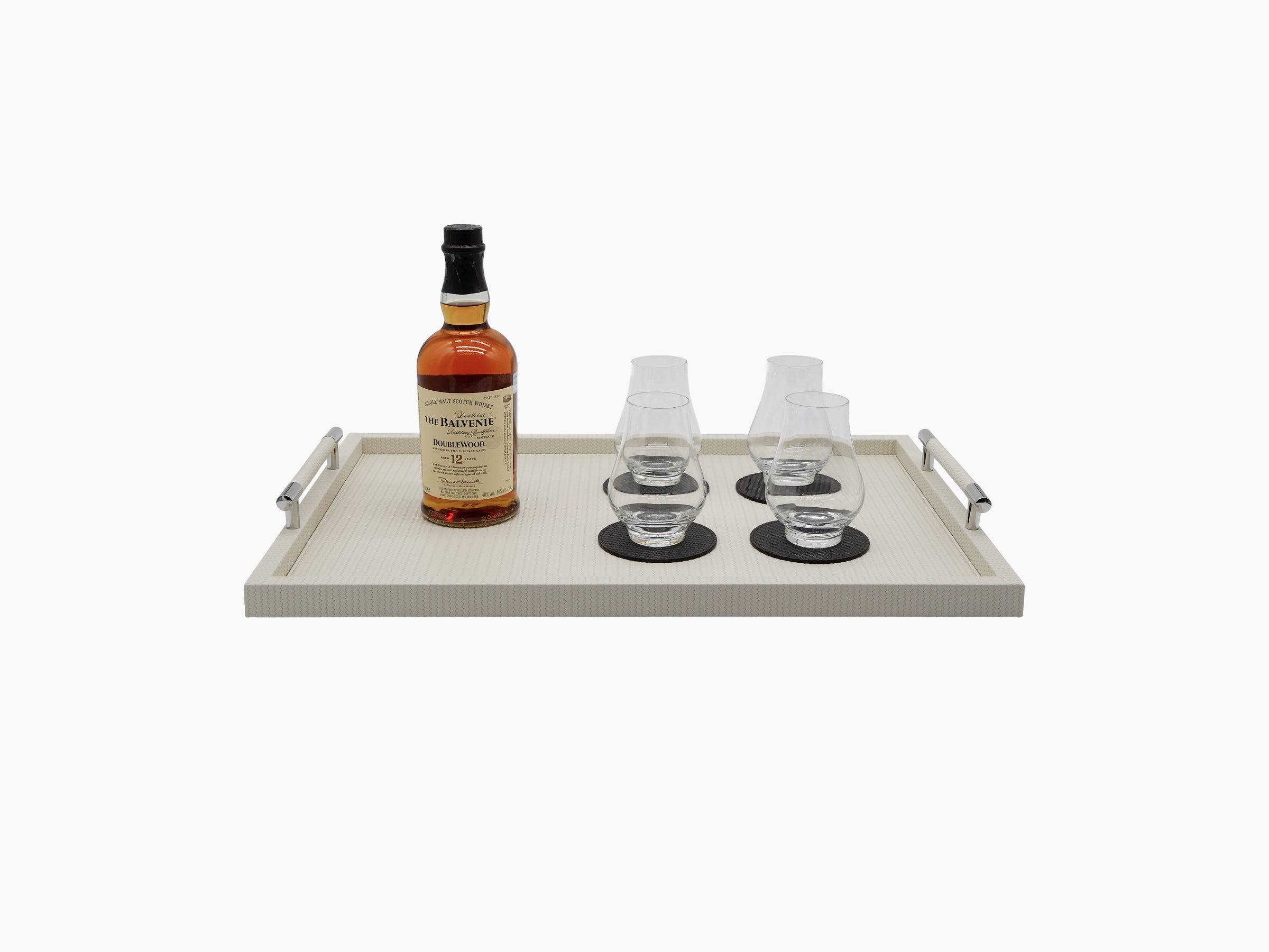 Large Dedalo Tray with a whiskey bottle and four stemmed glasses on a beige Florentine leather surface.