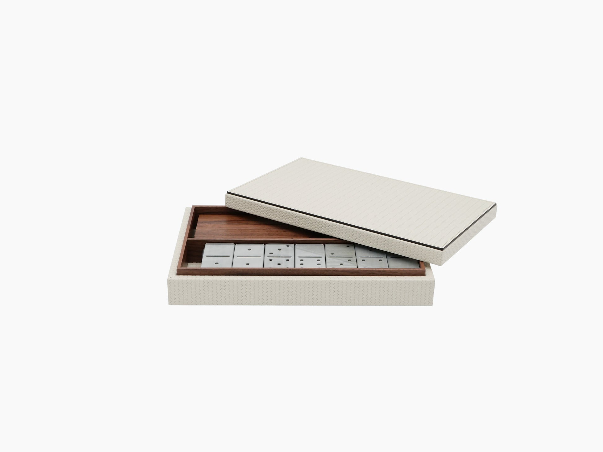 Dominoes set in a leather covered wooden box with white tiles arranged in a polished tray