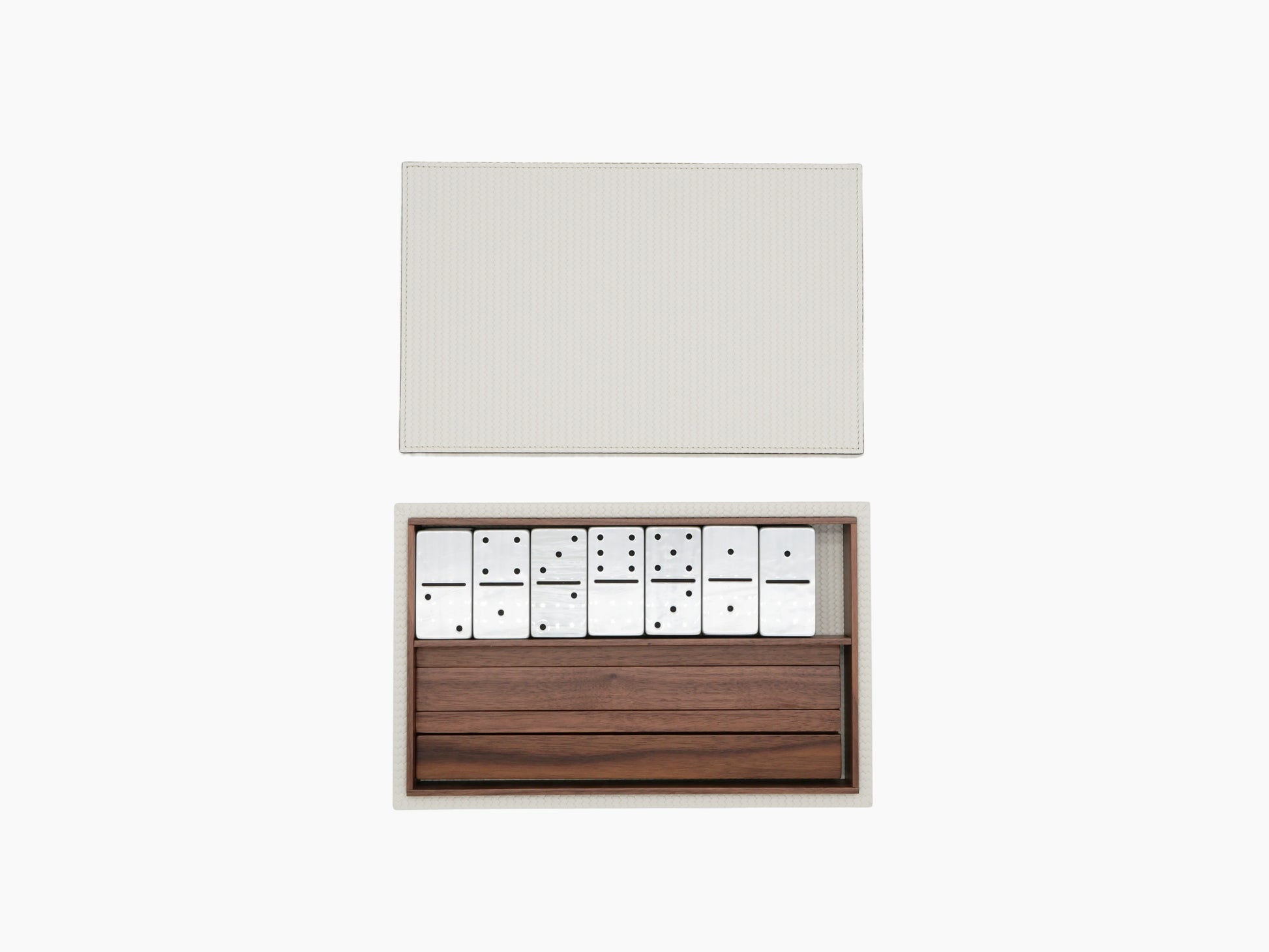 Box opened to reveal white domino tiles in a walnut Canaletto tray.
