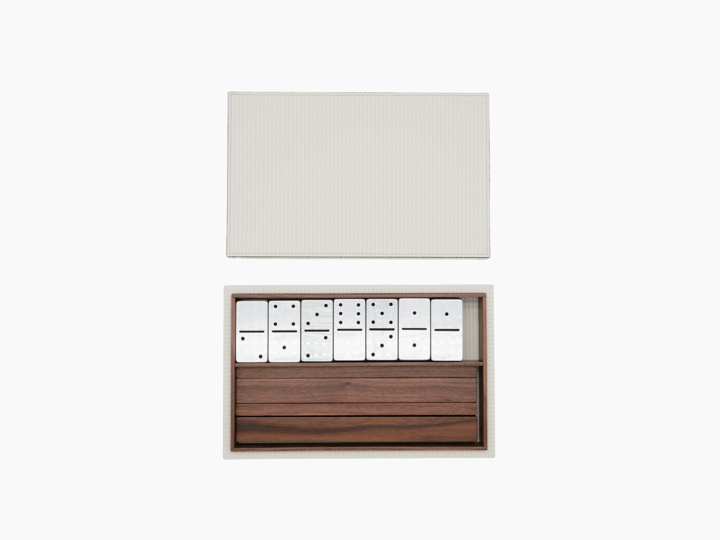 Box opened to reveal white domino tiles in a walnut Canaletto tray.