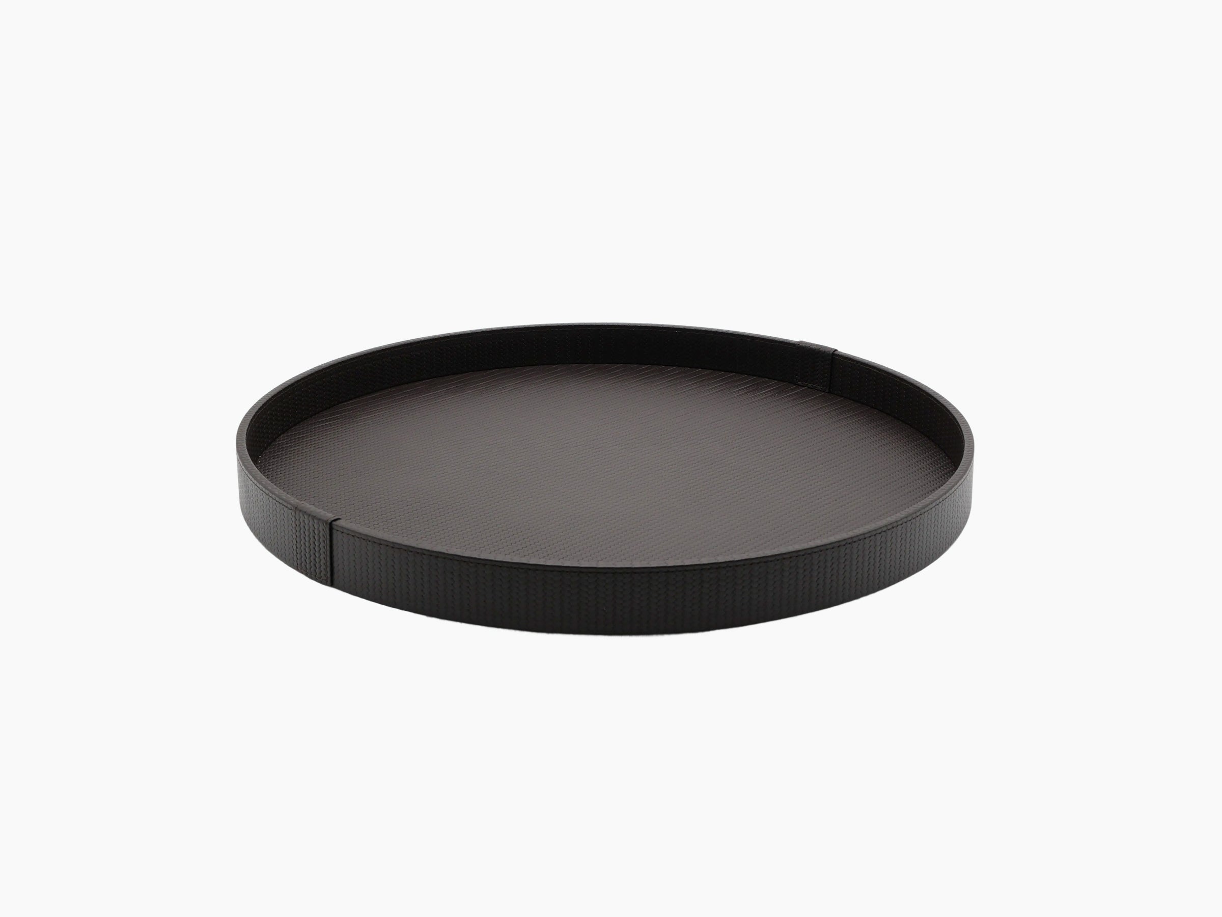Dark round leather tray with crocodile texture seen from an oblique angle.