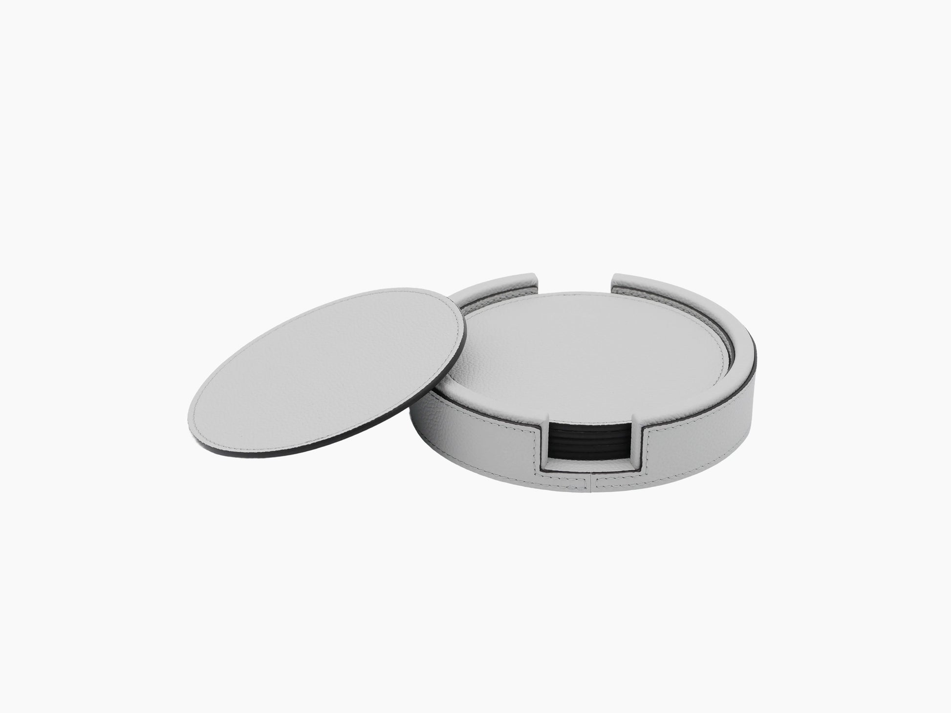 Gray round leather coaster holder with lid off showing inner ring and curved edges