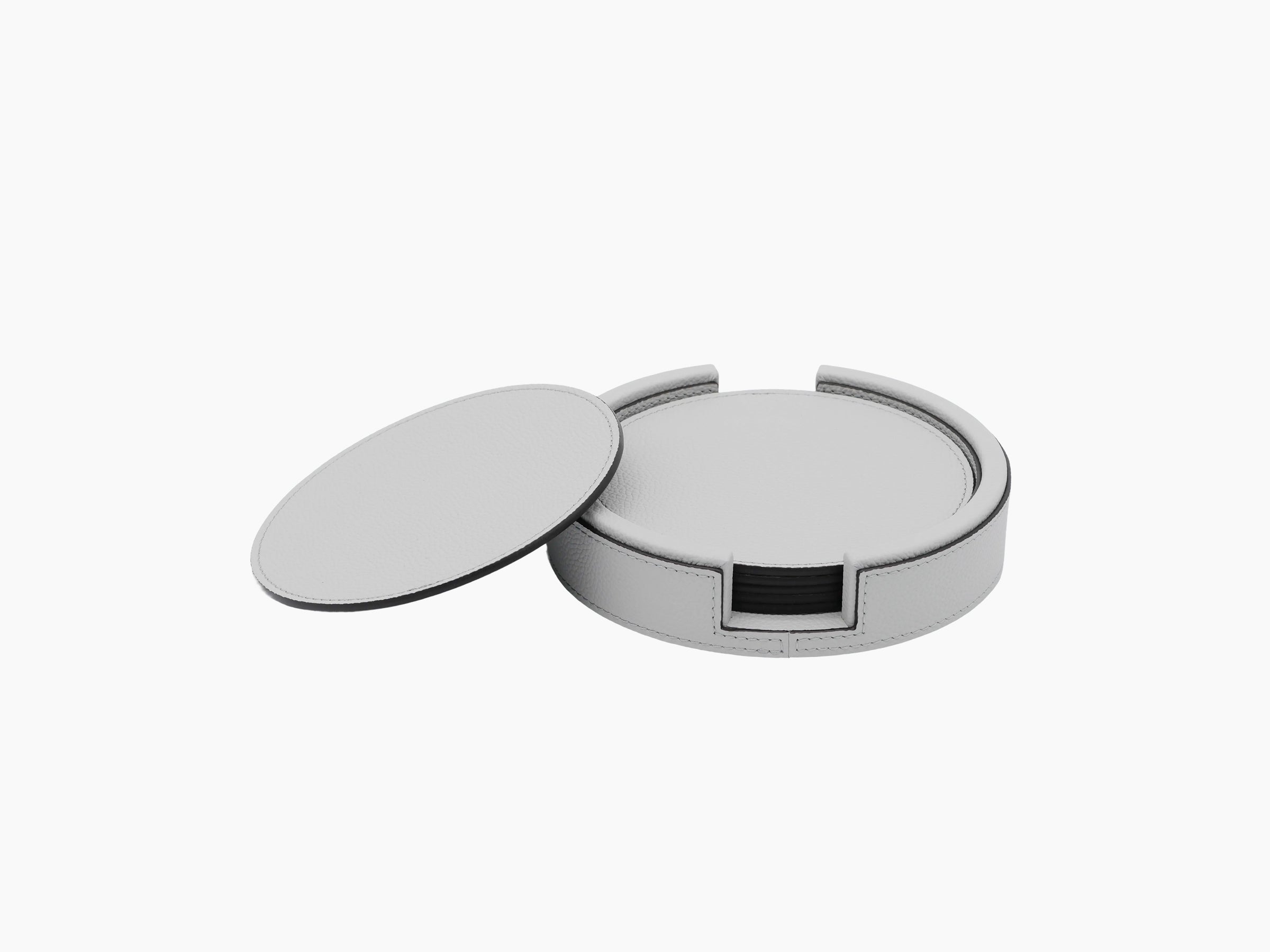 Gray round leather coaster holder with lid off showing inner ring and curved edges