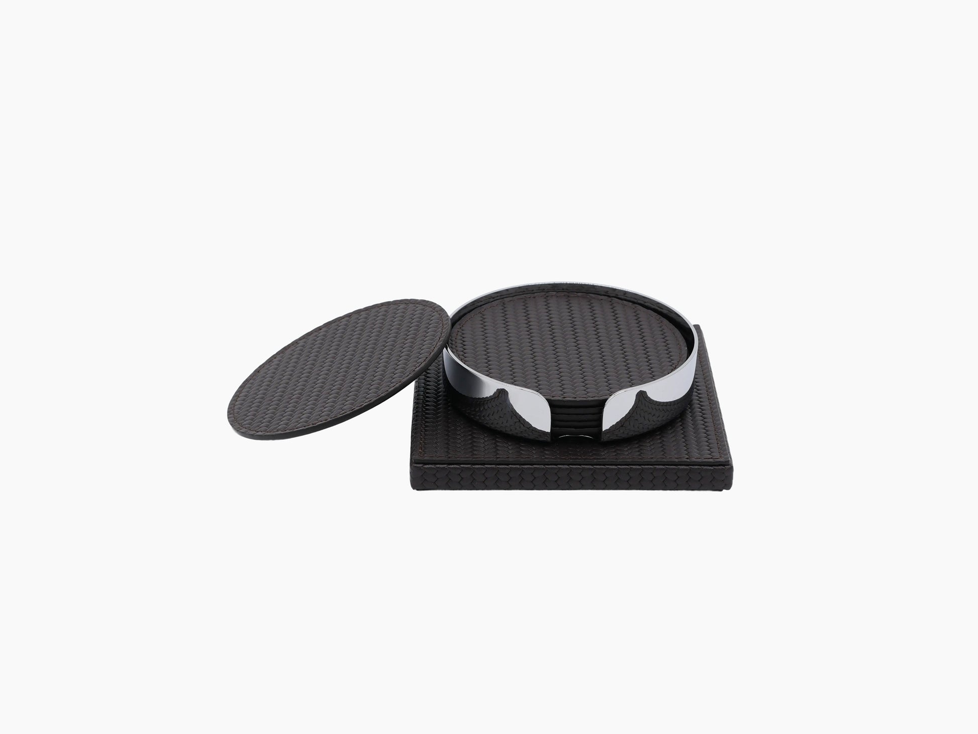 Dark leather wrapped square base supports a round chrome coaster holder with a loose round coaster nearby.
