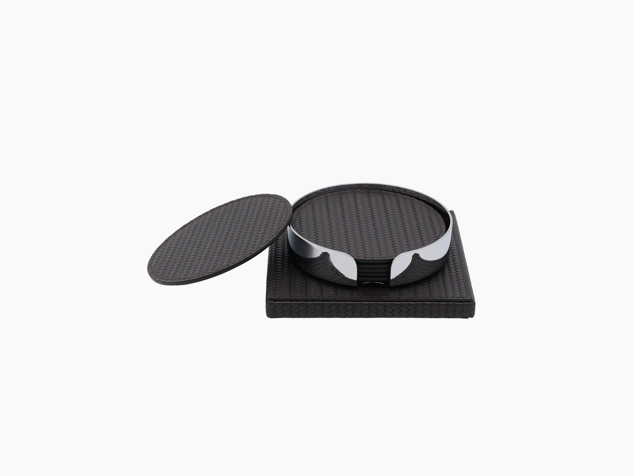 Dark leather wrapped square base supports a round chrome coaster holder with a loose round coaster nearby.