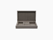 Open grey jewelry box with ring rolls and divided compartments inside soft suede lining