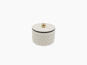 Cream round box with a gold lid knob and a stitched herringbone pattern around the sides.