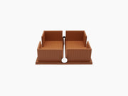Tan leather two section napkin holder with a weighted chrome bar and white circular weight at the front