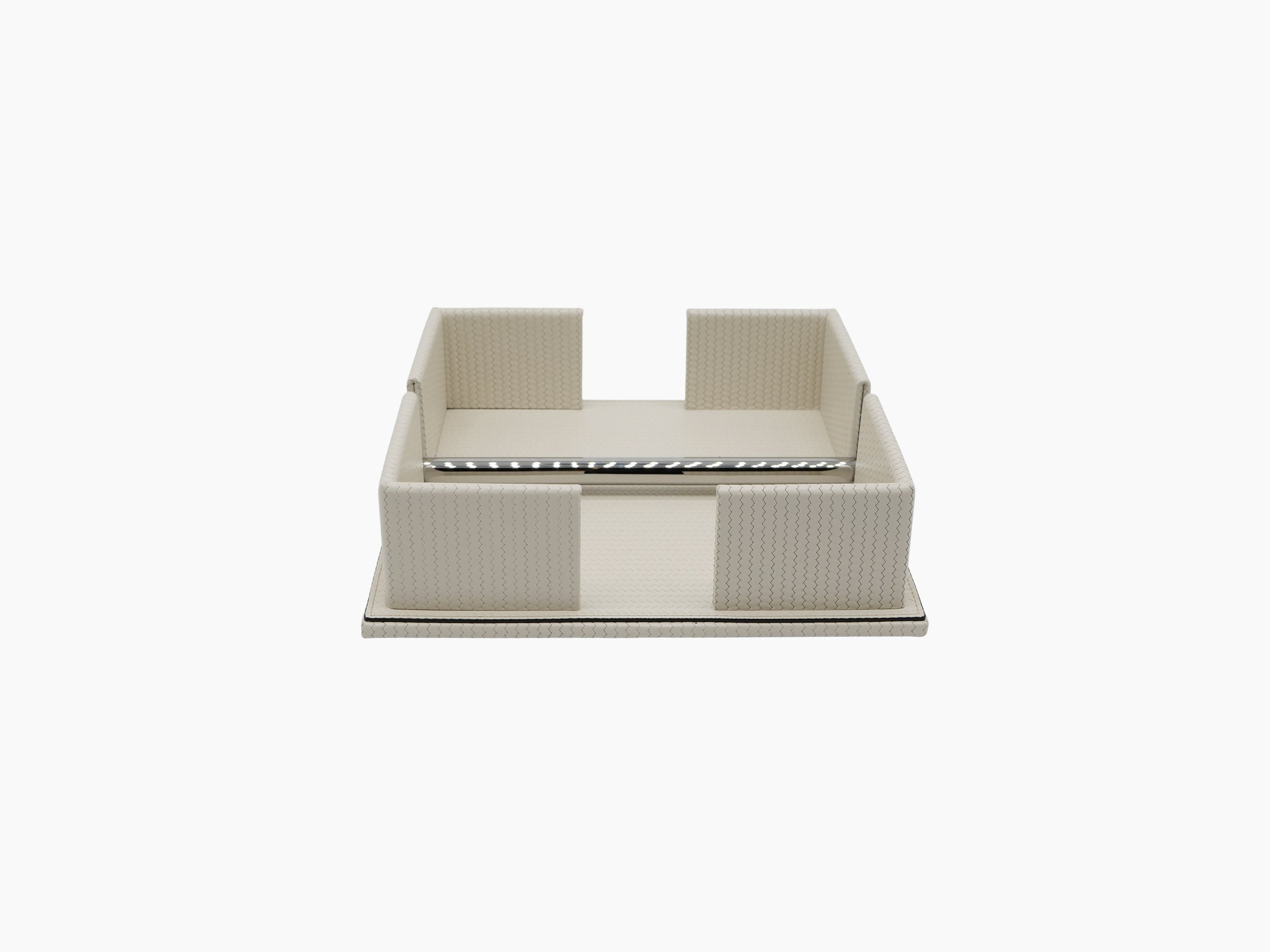 Cream leather napkin holder with a weighted chrome bar along the front edge