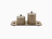 Two beige leather round boxes on a rectangular tray with chrome accents from the Medium Olimpia Round Bathroom Set