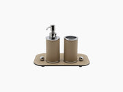 Small Olimpia beige leather rectangular tray holding two cylindrical containers with chrome trim and a pump dispenser.