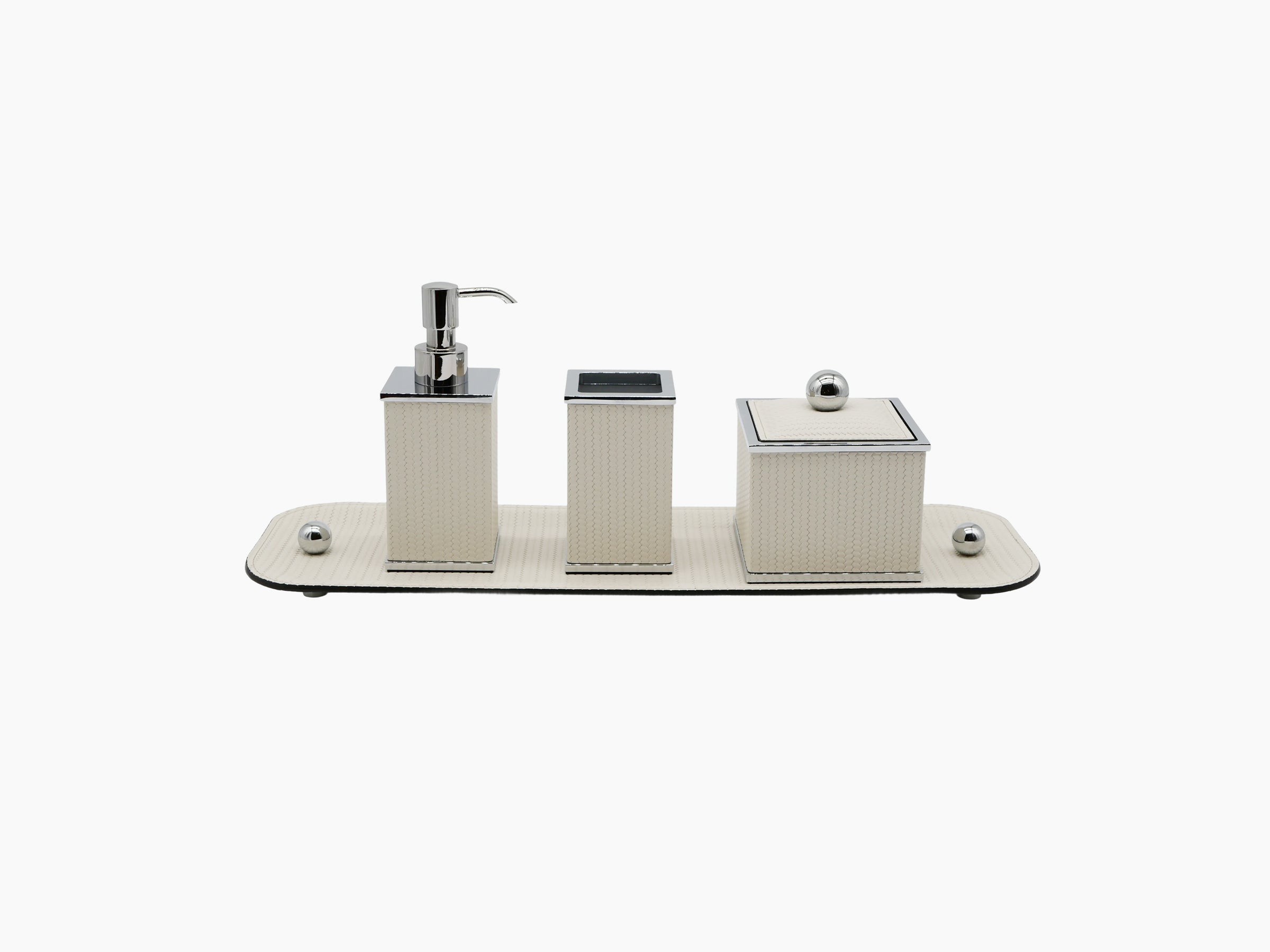 Three-piece Olimpia bathroom set on beige leather tray with chrome trim including a soap dispenser rectangular holder and a lidded box.