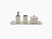 Olimpia Square Bathroom Set with a soap dispenser toothbrush holder and cotton pad container on a rectangular beige leather tray with chrome accents.