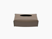 Leather wrapped rectangular tissue box with an oval top opening