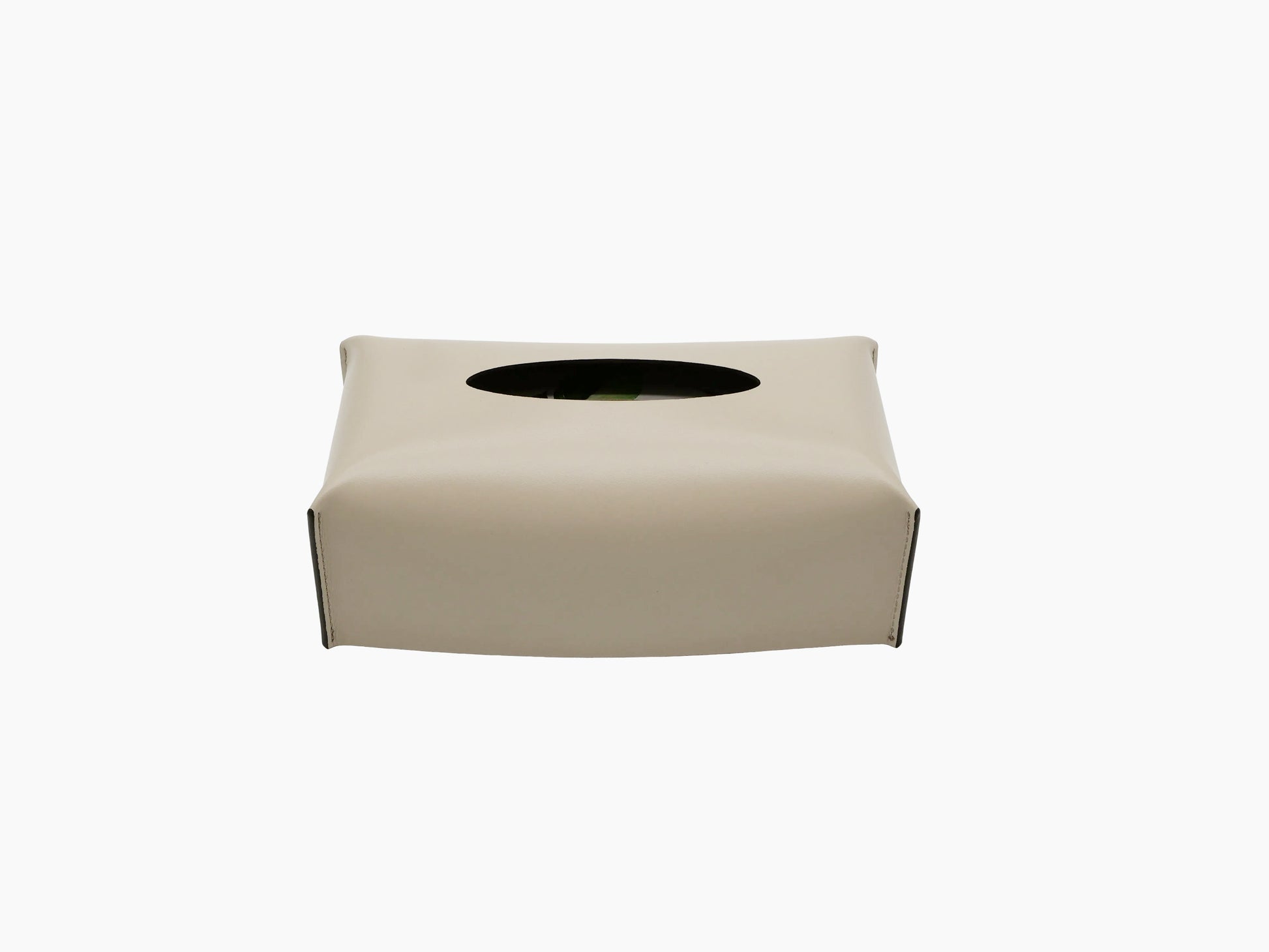 Cream leather wrapped rectangular tissue box with an oval top opening