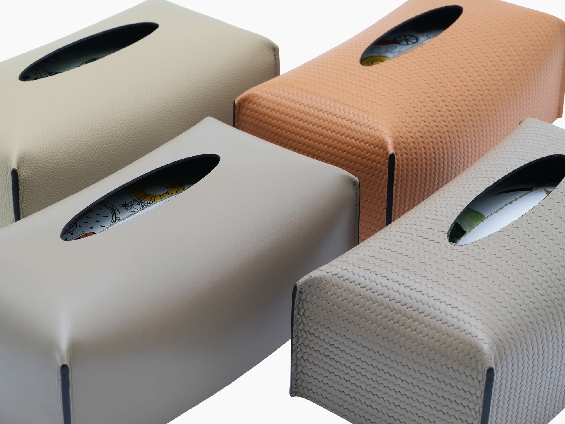 Assorted leather tissue boxes in different colors with oval top openings