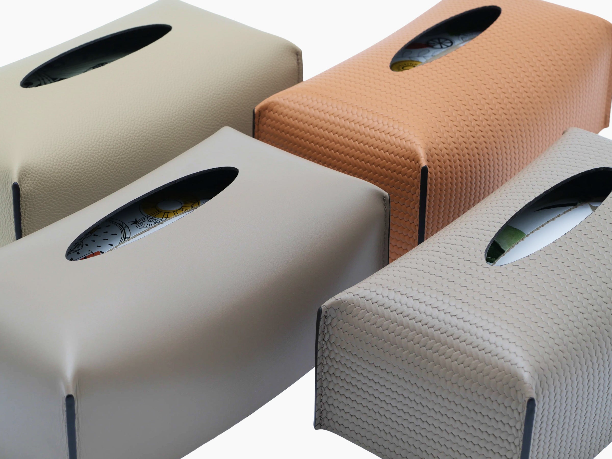 Assorted leather tissue boxes in different colors with oval top openings