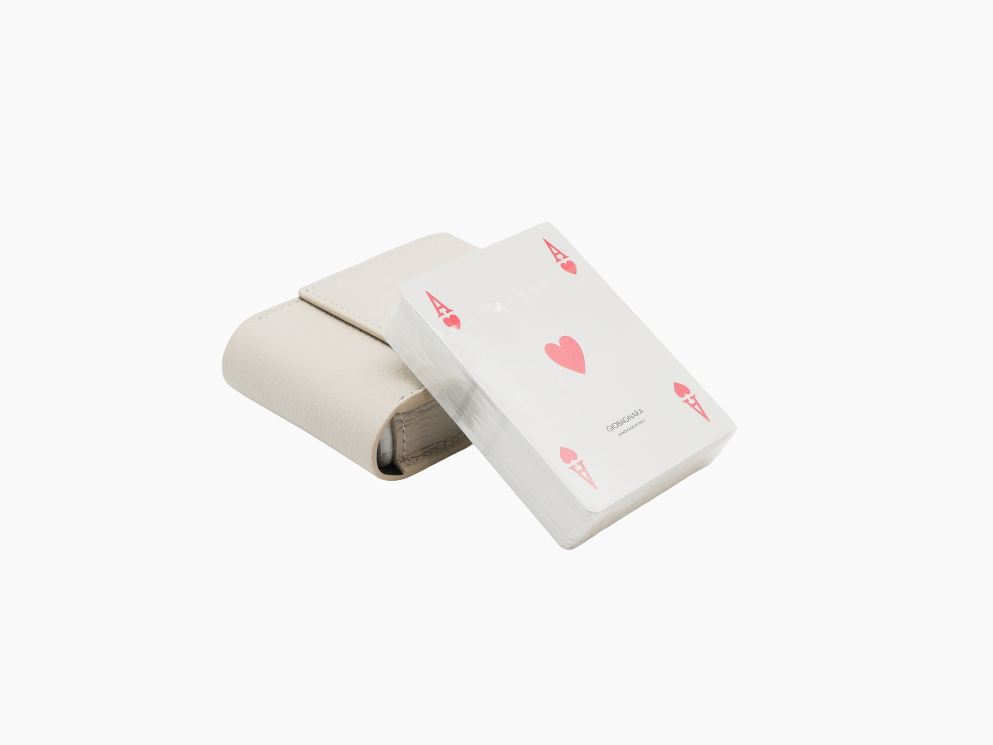 Beige Pelle Frau leather card holder beside a wrapped deck of Giobagnara playing cards