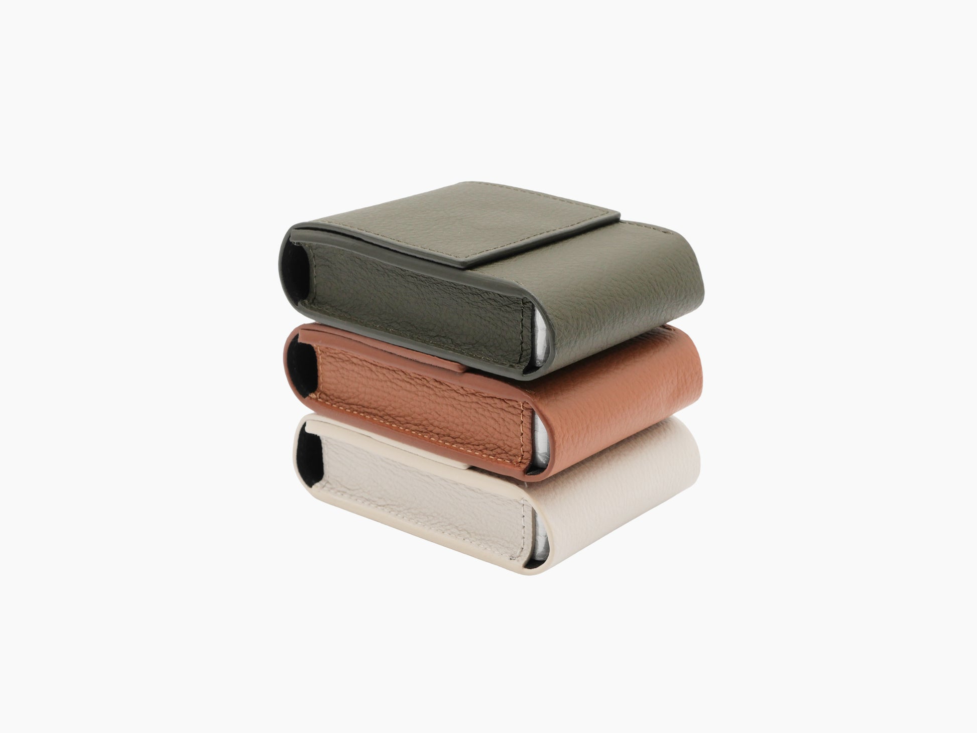 Three Pelle Frau leather playing card pochettes stacked in green brown and beige