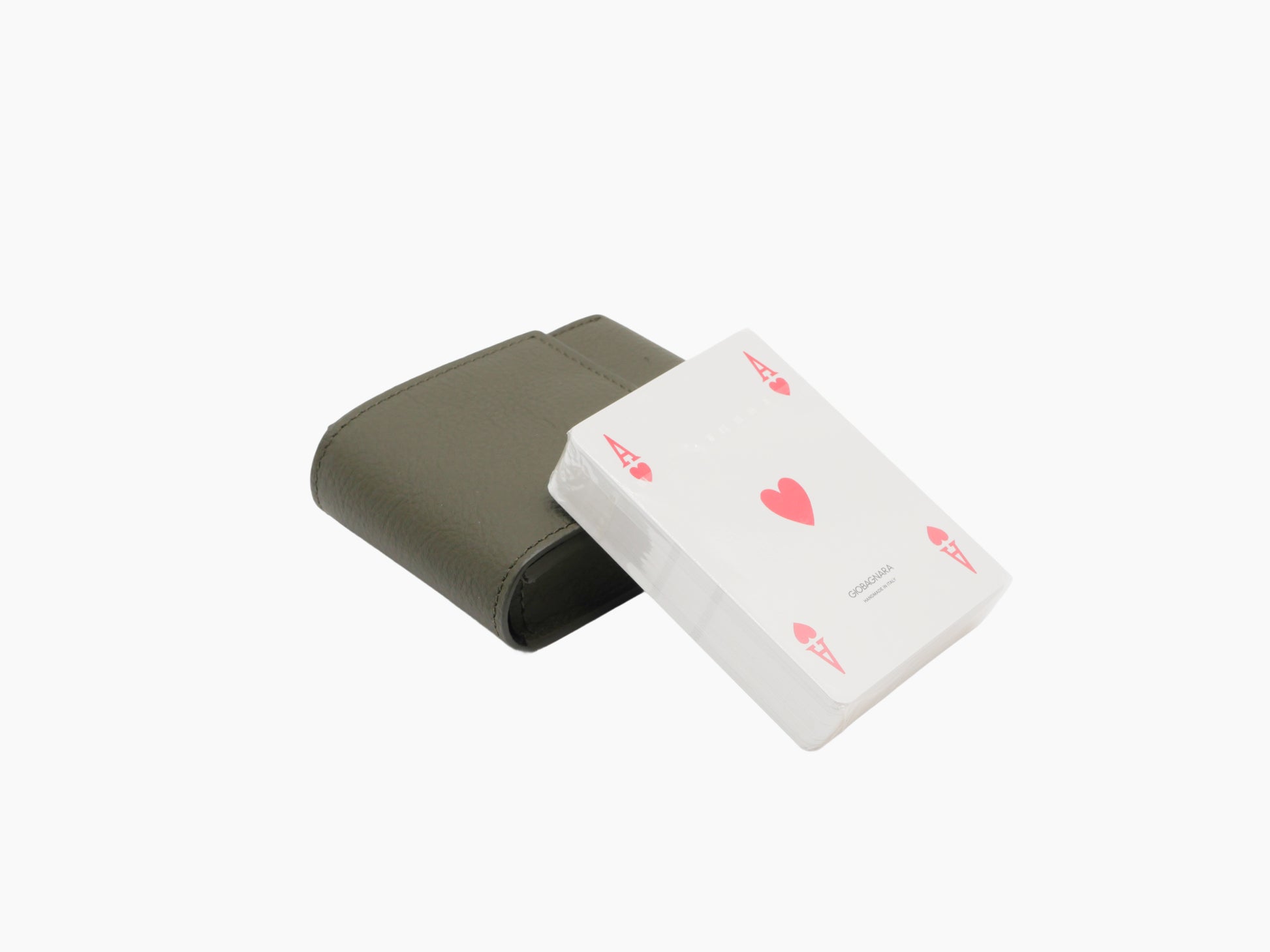 Olive green Pelle Frau leather card holder with a deck of playing cards partly visible.