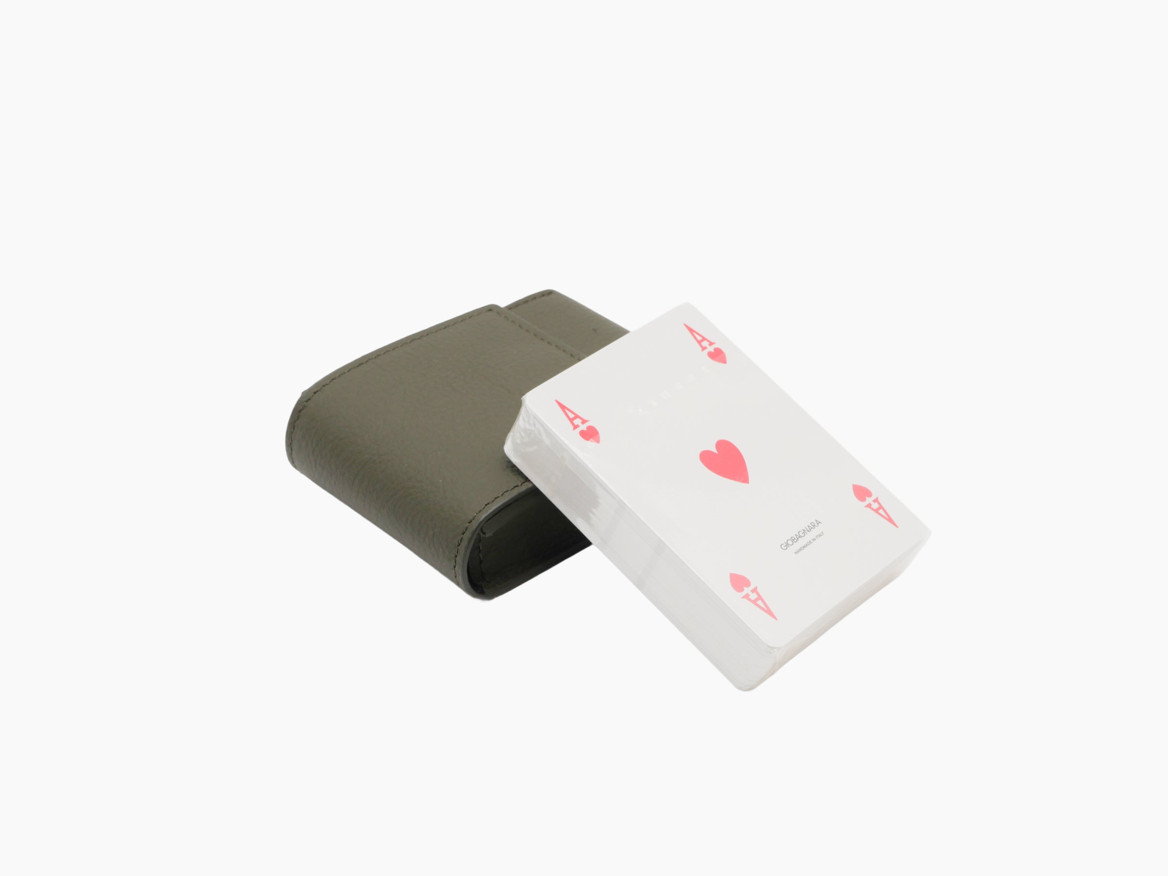 Olive green Pelle Frau leather card holder with a deck of playing cards partly visible.
