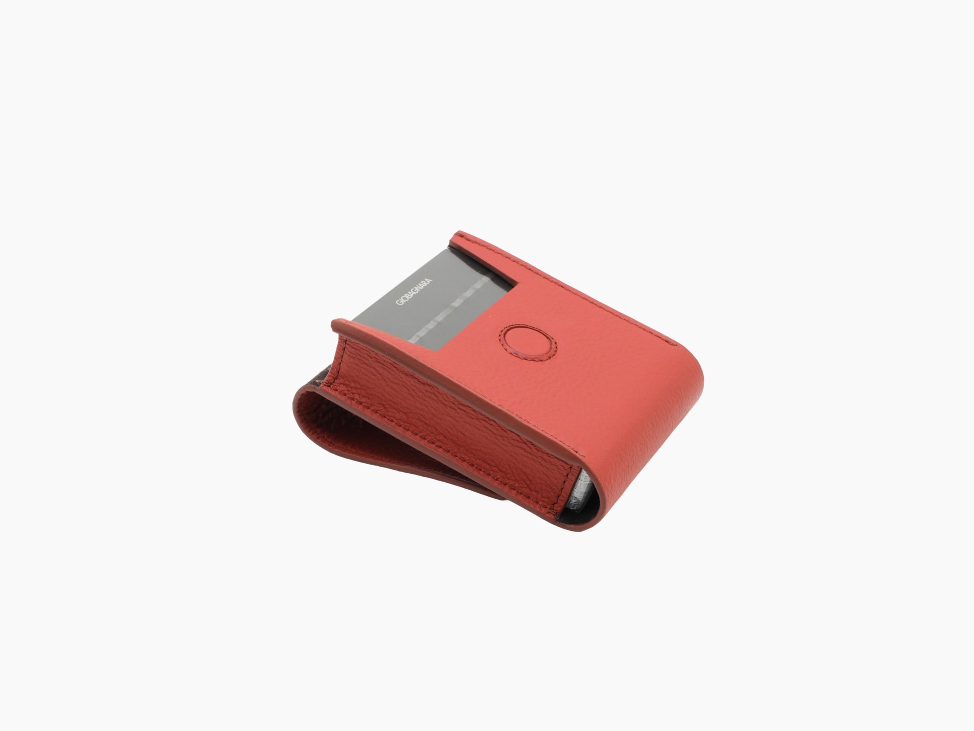 Coral pink Pelle Frau leather card holder with a gray card partially inserted