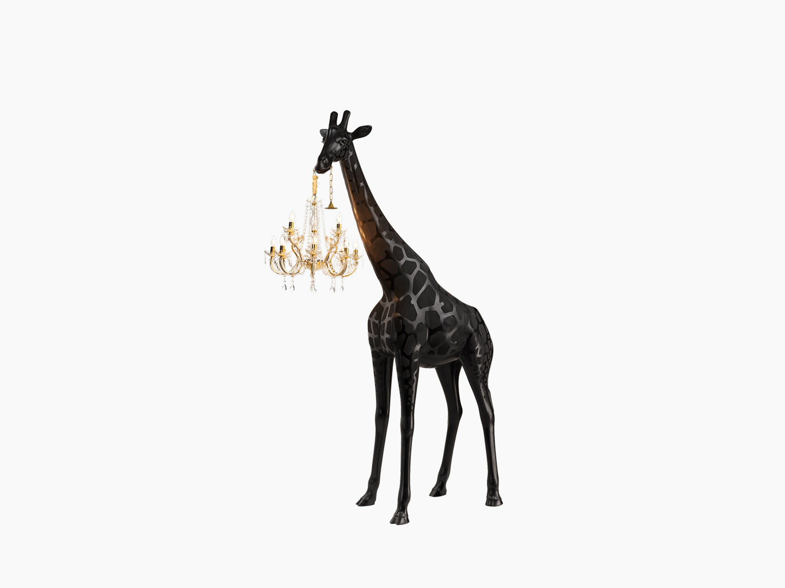 Black Giraffe in Love XS sculpture holding a gold Marie-Thérèse style chandelier around its neck in a clean studio setting.