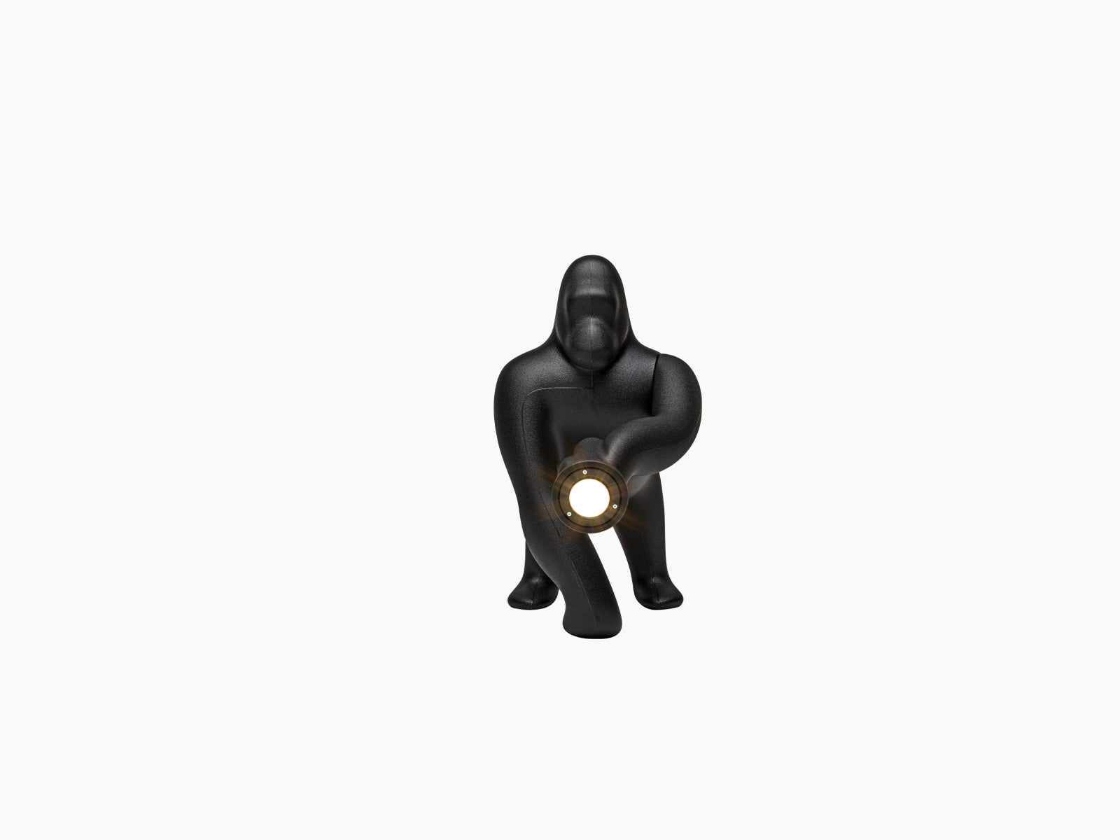 Kong Lamp XS in black showing a crouching gorilla sculpture with an adjustable arm and a round light source in its hand.