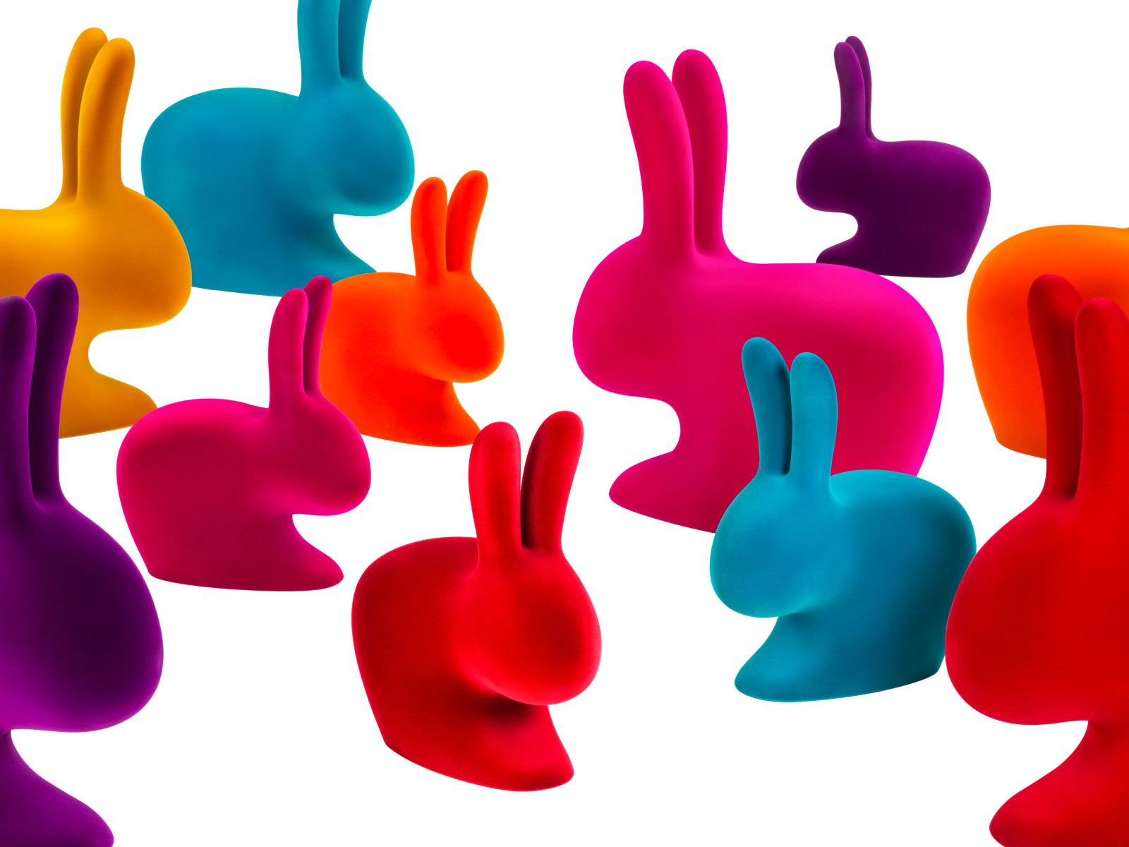 Line of rainbow rabbit chairs in bright colors including yellow, blue, purple, pink and orange