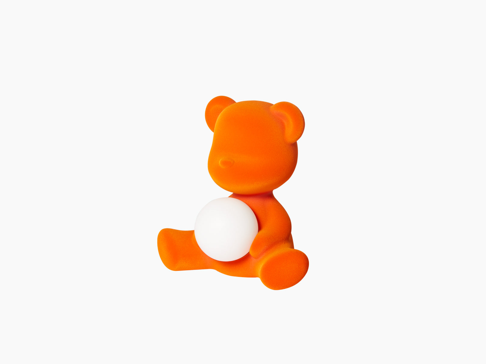 Side view of the orange Velvet Flock Teddy Girl LED lamp cradling a glowing white sphere.