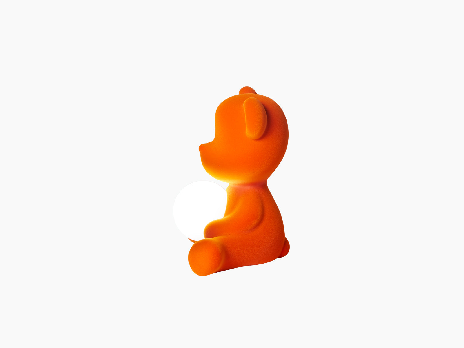 Back view of Teddy Girl lamp in orange velvet with a white sphere beside it