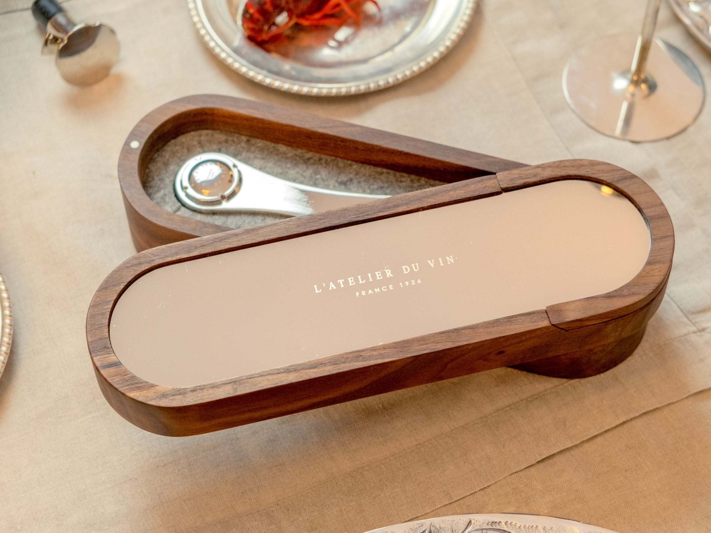 Walnut wood Sparkling Set case open to reveal a polished corkscrew for Champagne.