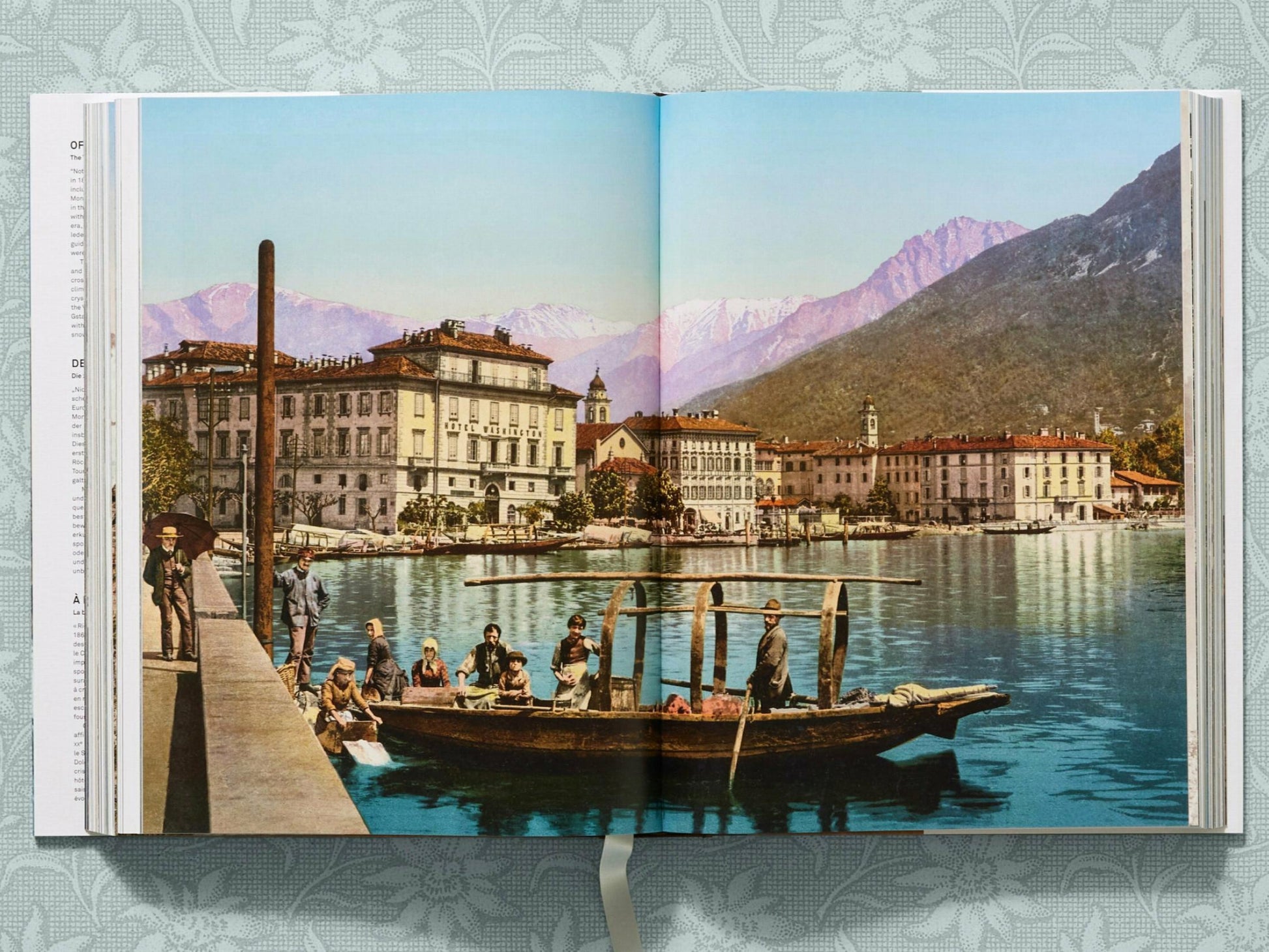 Lakeside alpine town with a boat on calm water and snow capped mountains in the distance from The Alps 1900 A Portrait in Color