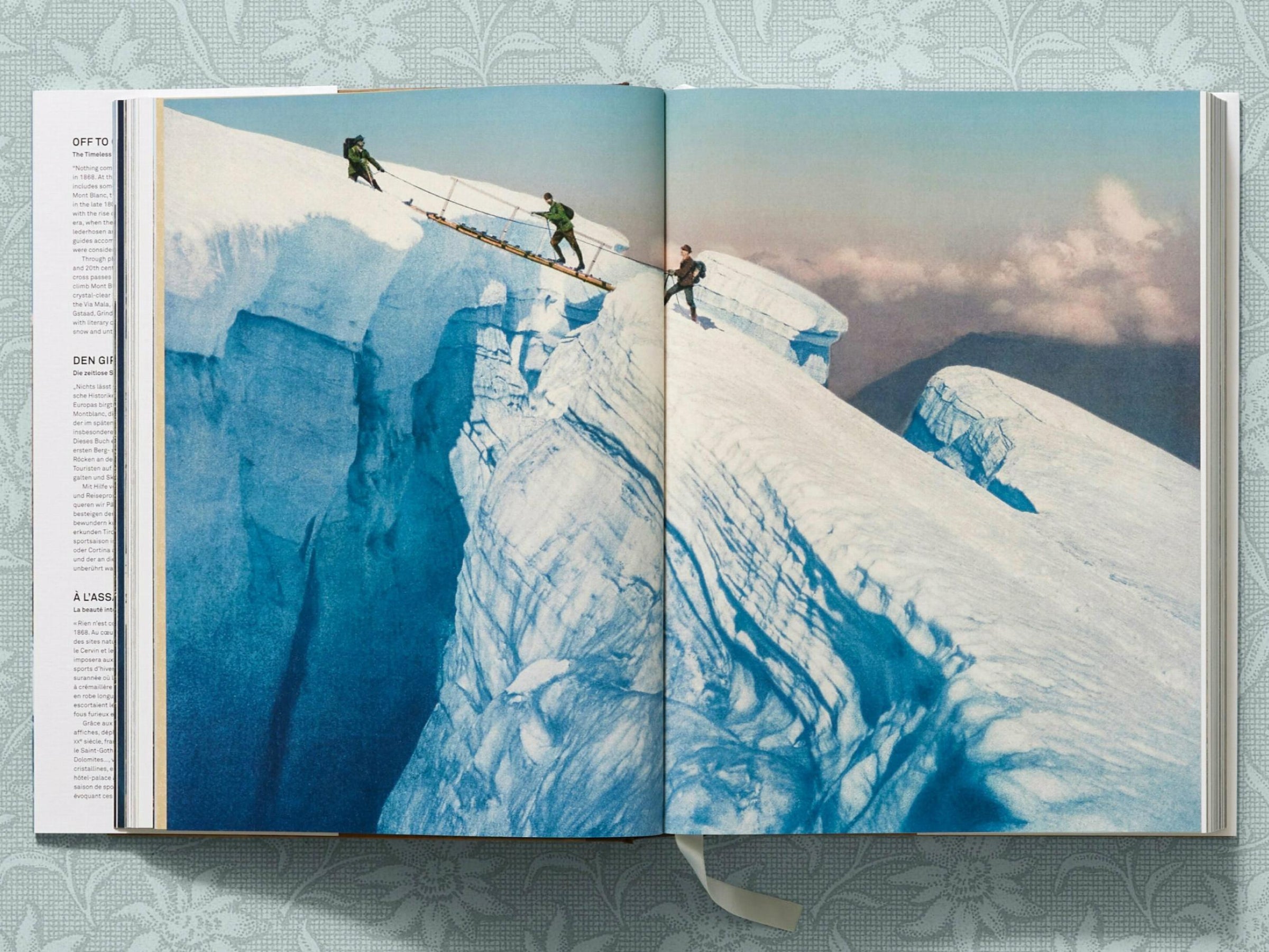 Open book spread with a vast blue glacier on the left and a small alpine image on the right page