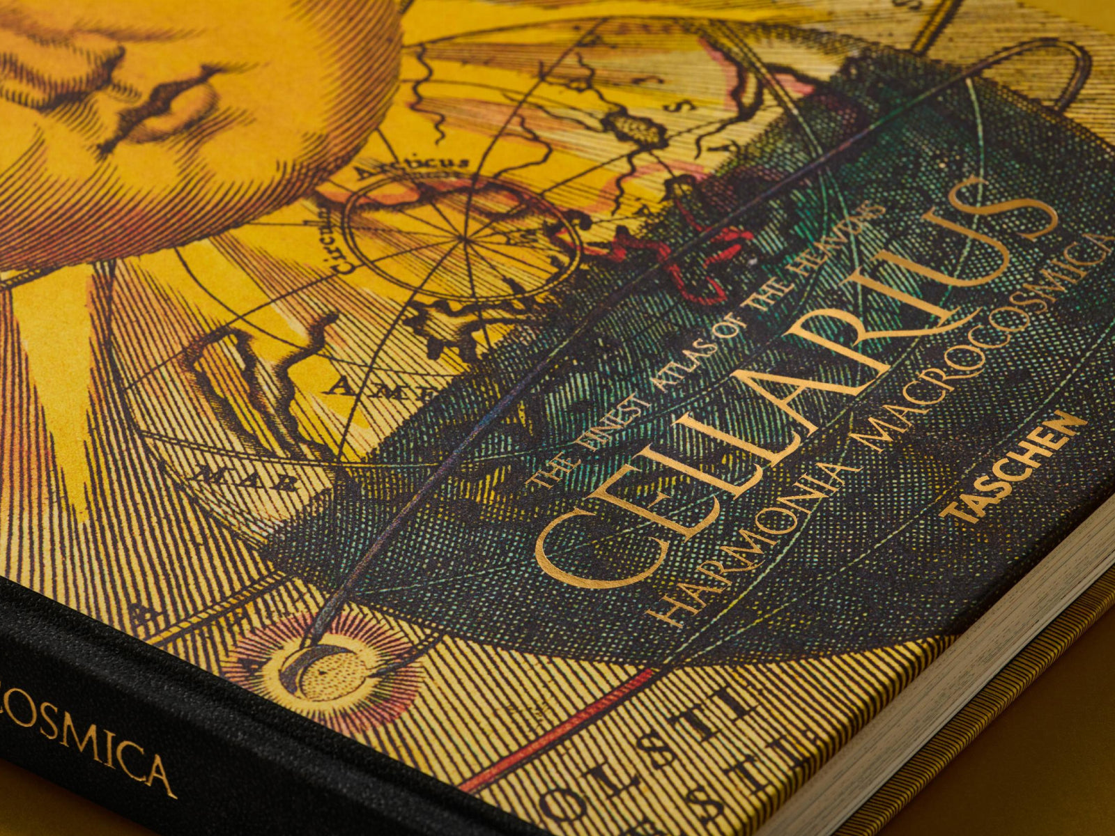 Front cover of Cellarius Atlas Harmonia Macrocosmica showing vintage map artwork in yellow and teal with gold title text.