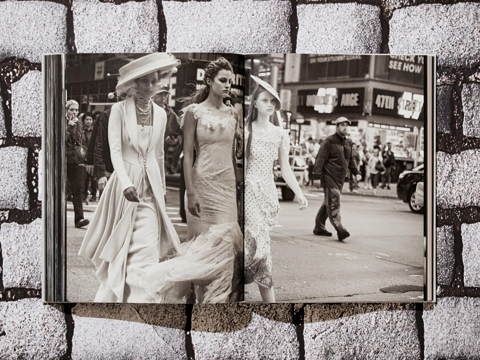 Open double-page spread from the Peter Lindbergh Dior book showing black-and-white street fashion with two models in gowns