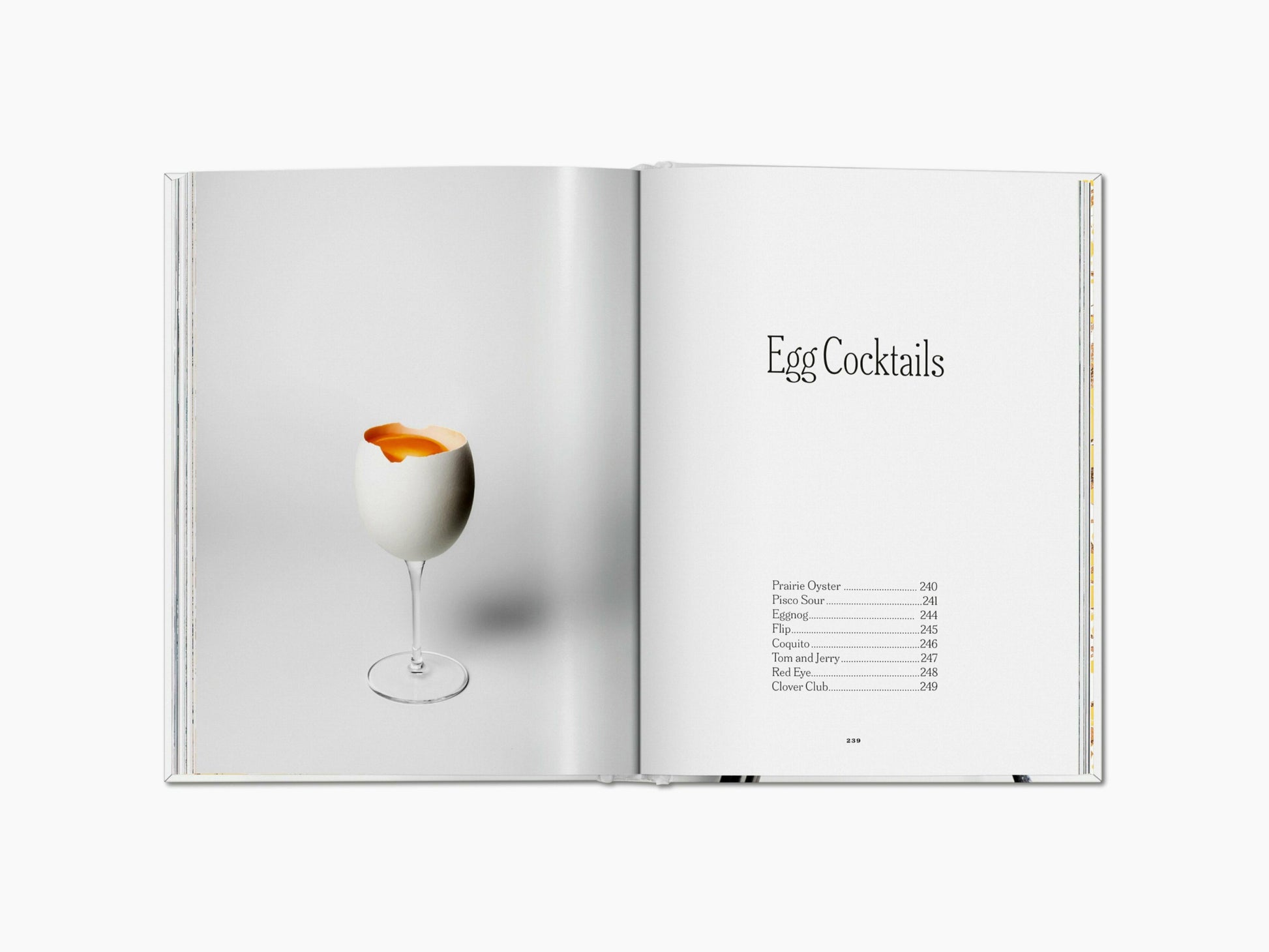 Egg cocktail in a tall stem glass with the yolk visible against a pale background