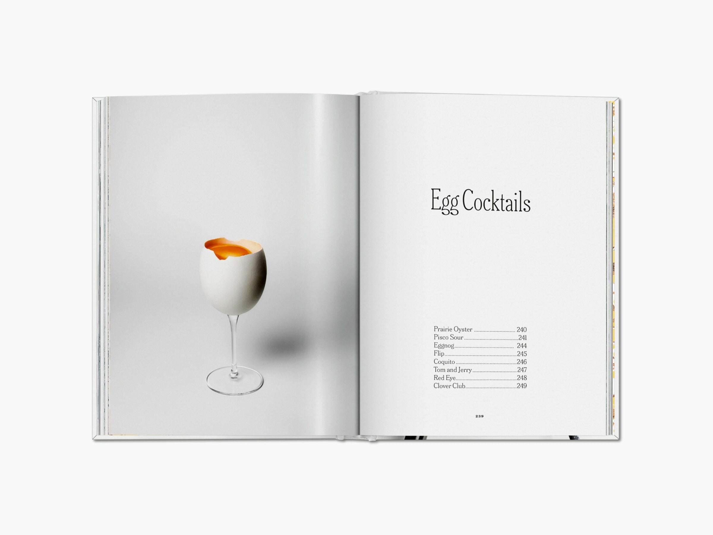 Egg cocktail in a tall stem glass with the yolk visible against a pale background