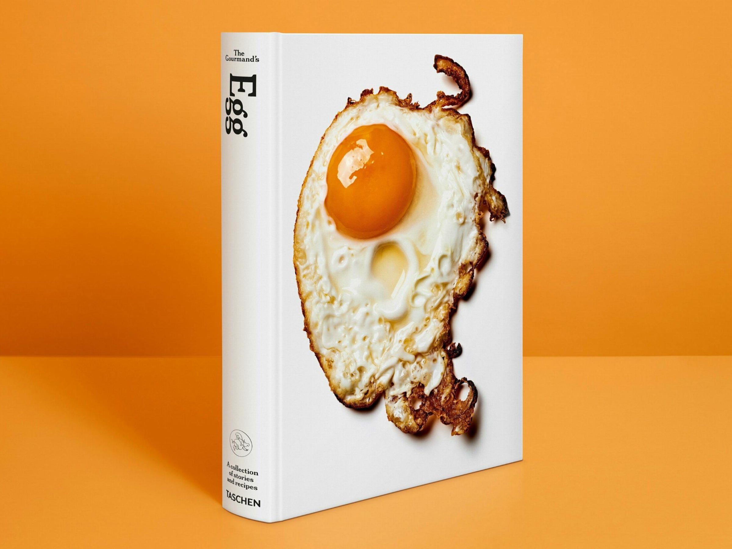 The Gourmand’s Egg book cover showing a fried egg on white with an orange backdrop