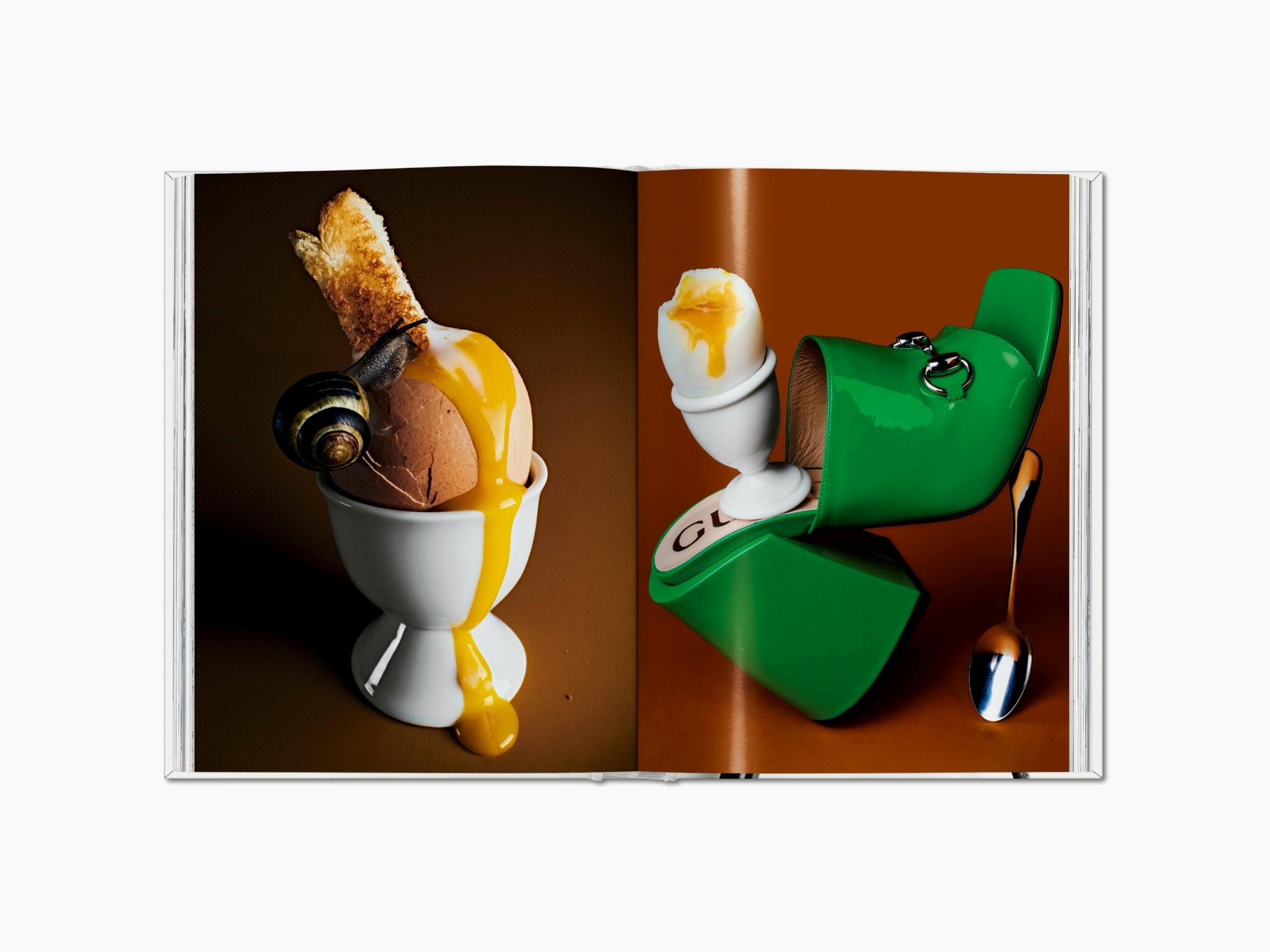 Two page spread shows a cracked egg in an egg cup with dripping yolk on the left and a bright green handbag on the right.