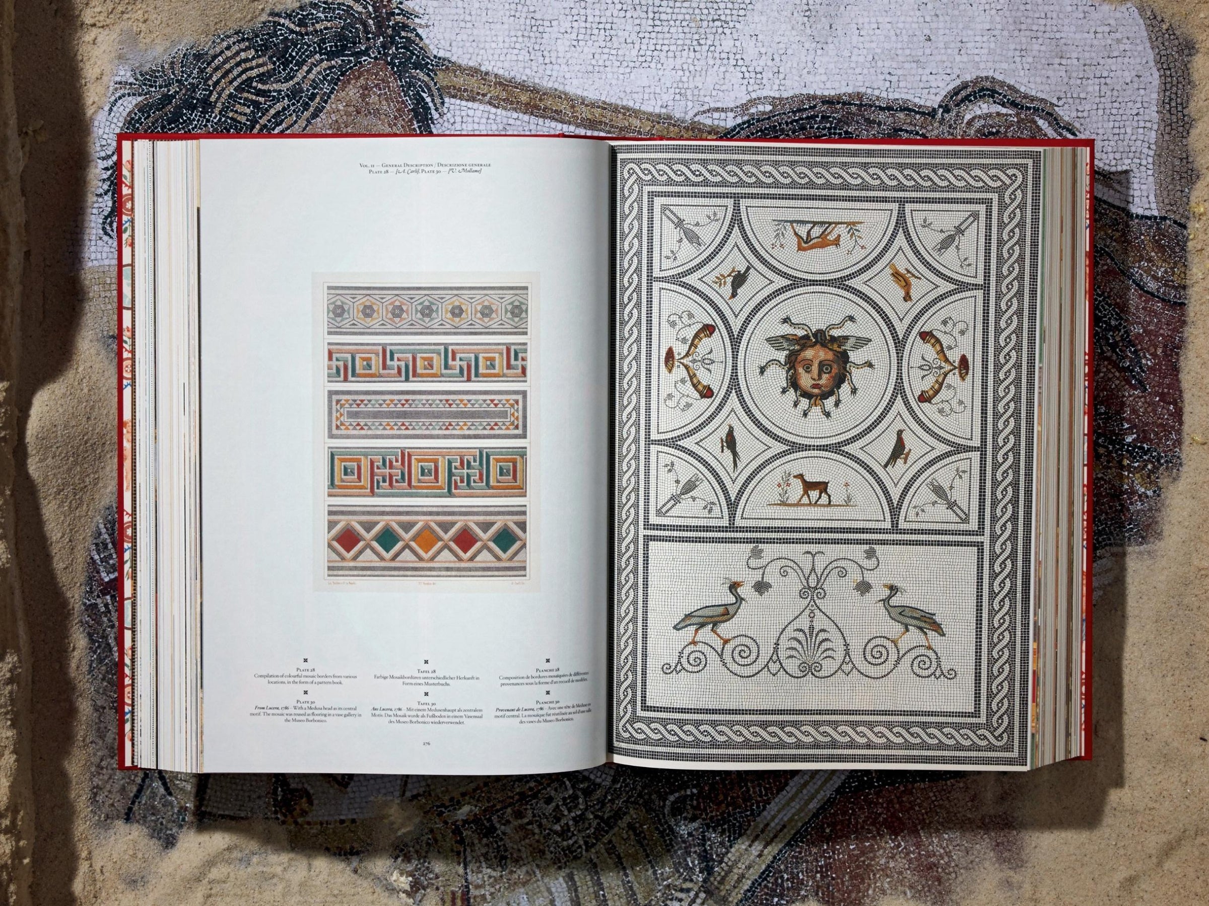 Open spread from Fausto & Felice Niccolini Pompeii volume showing left page with geometric pattern panels and right page a circular sun mosaic.