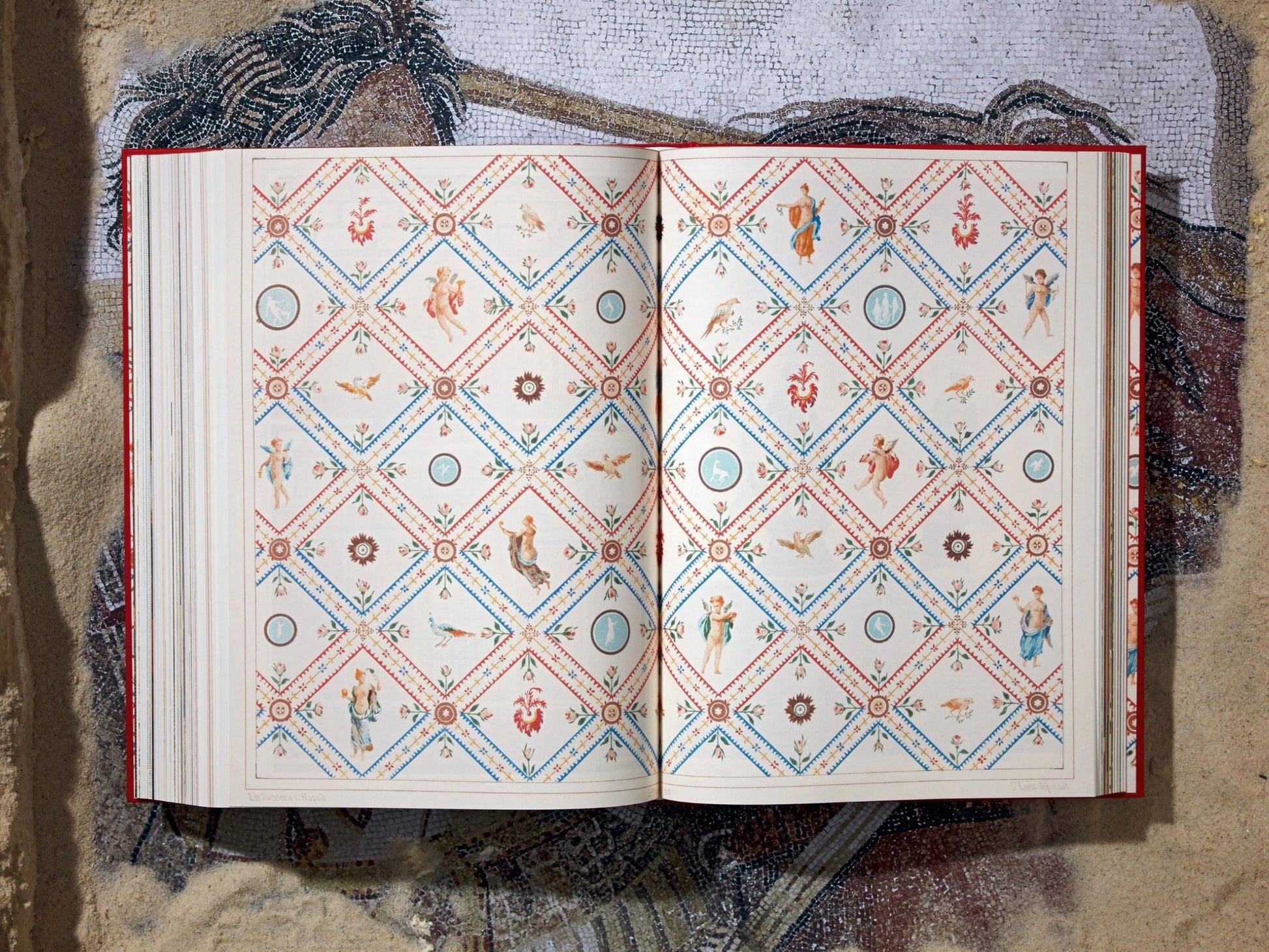 Open book showing a vivid diamond lattice pattern with tiny figures and floral motifs across both pages.