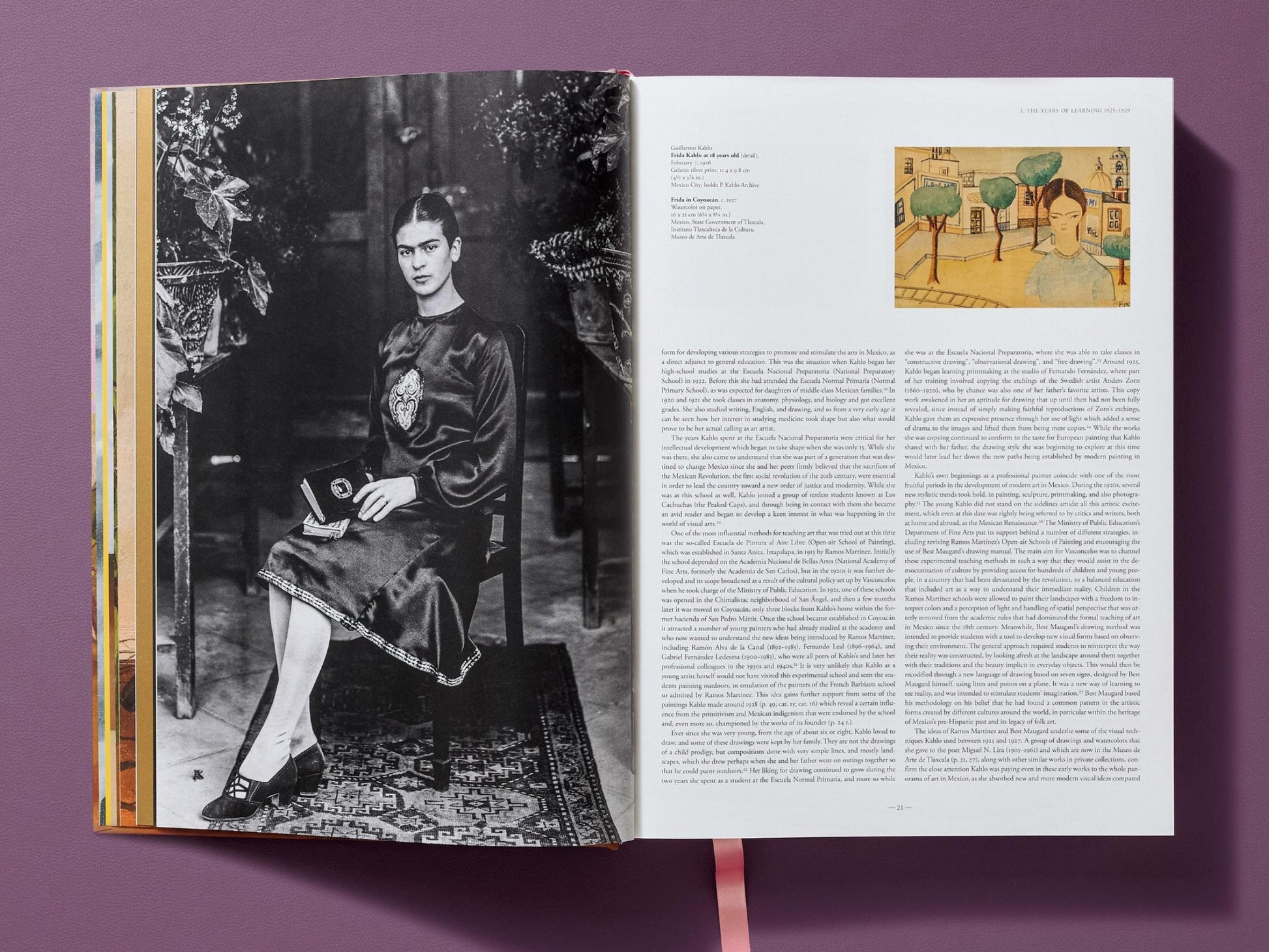 Open Frida Kahlo The Complete Paintings spread showing a black and white portrait on the left and a text heavy right page with a small inset painting.