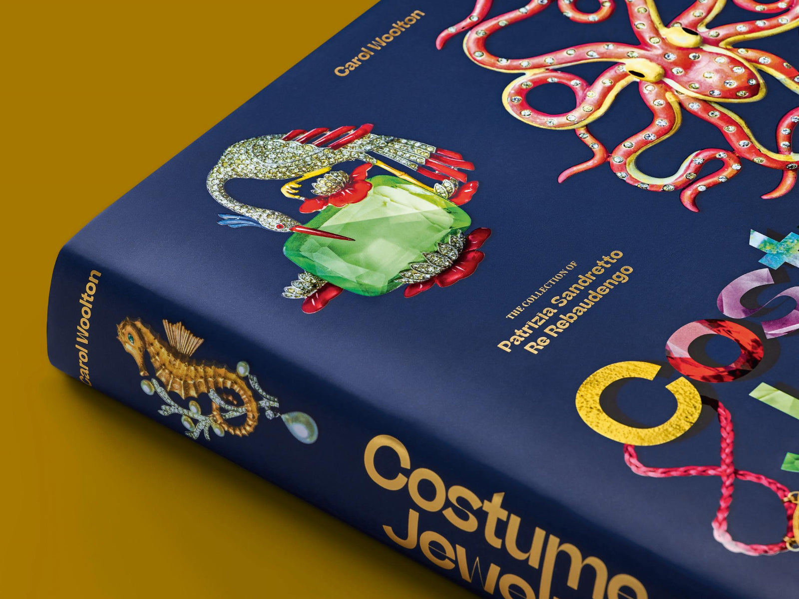 Blue cover of Costume Jewelry with a pink jeweled octopus and a large green centerpiece.