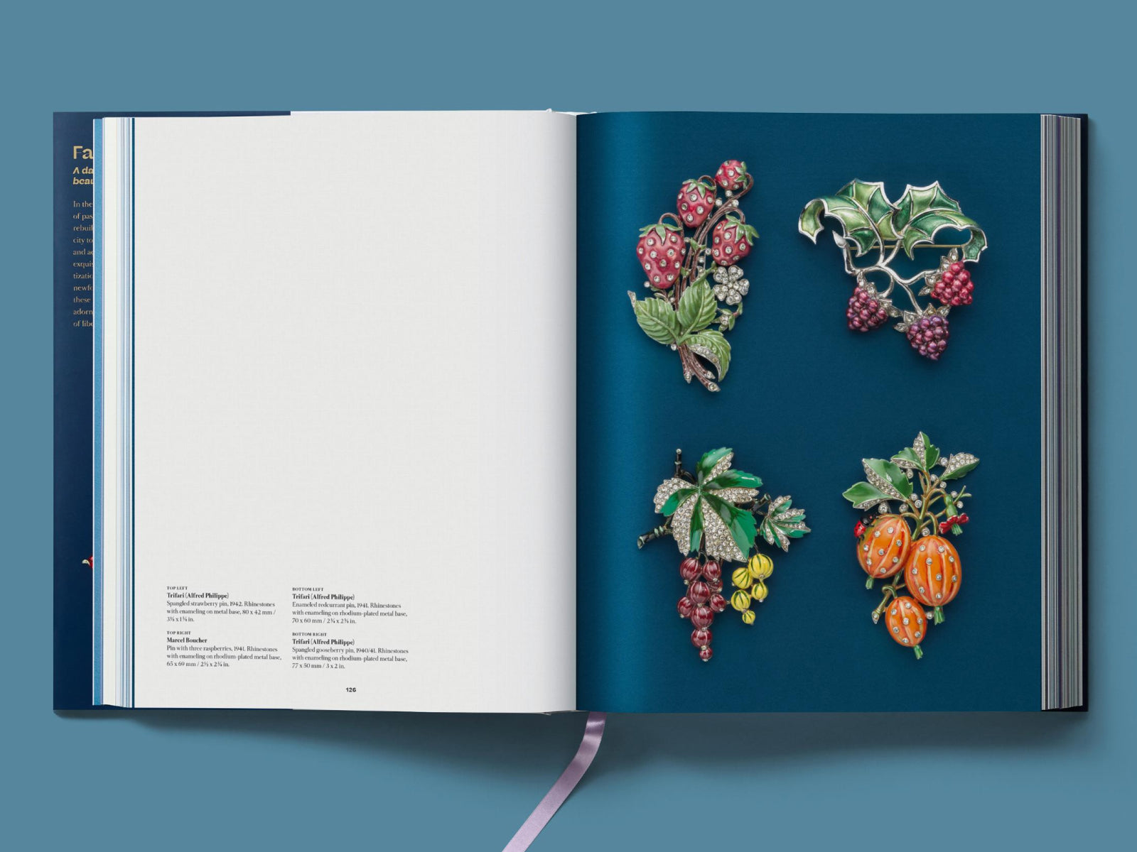 Open book spread with four colorful jeweled brooches arranged on a deep blue page.