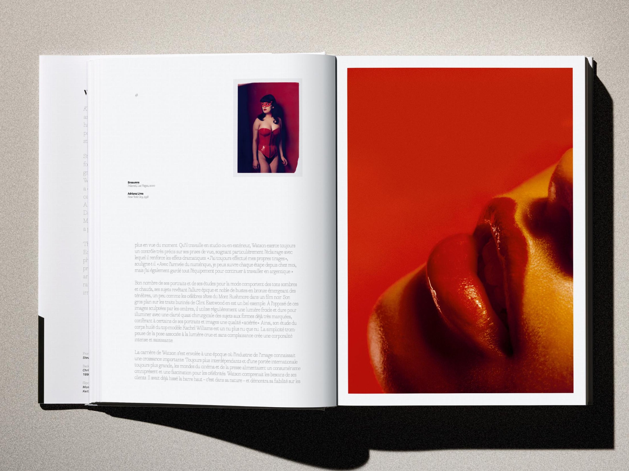 Open book spread with a small inset portrait of a woman in a red corset on the left and a large red lip close up on the right.