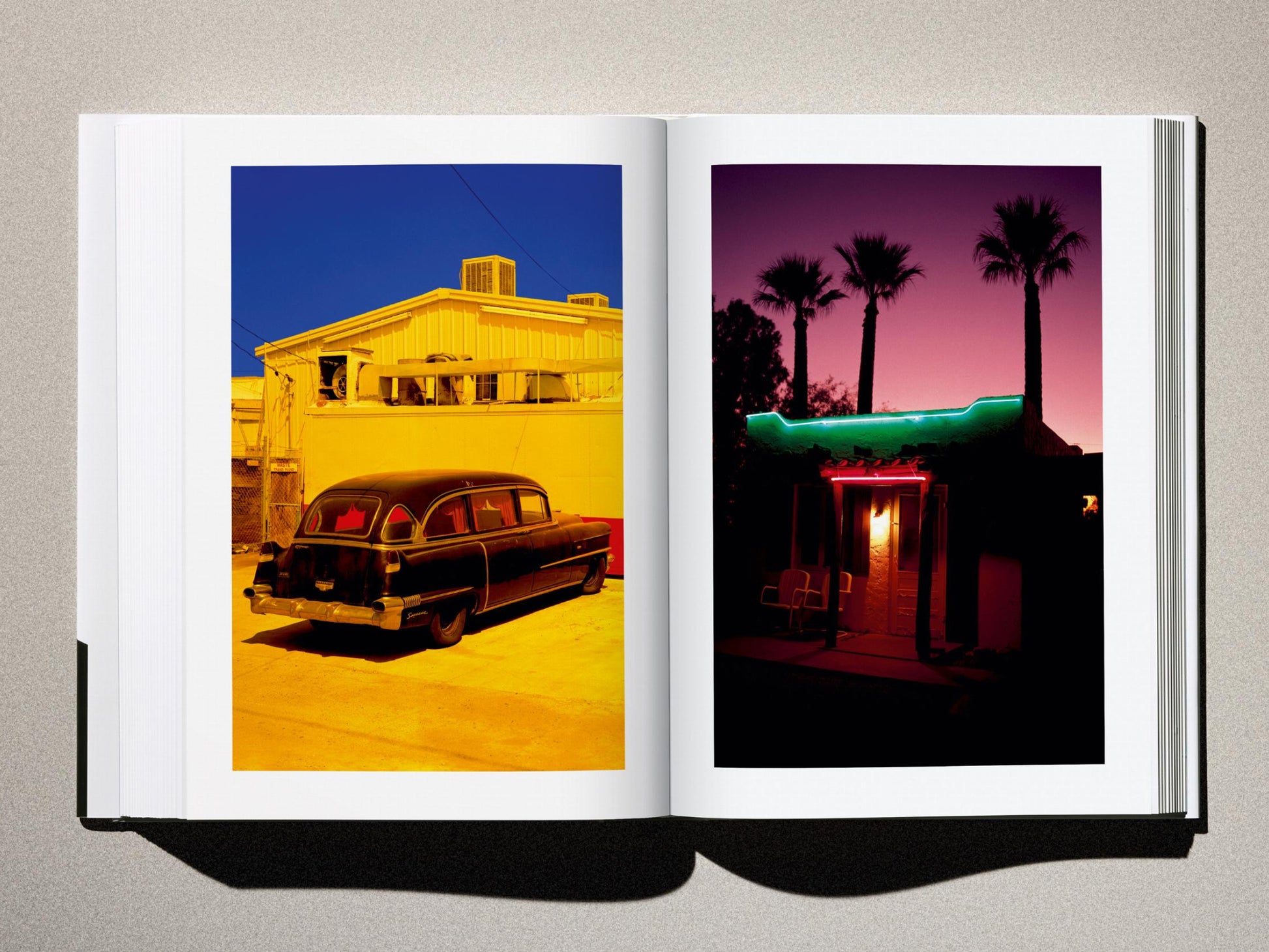 Left page shows a vivid yellow building with a vintage car; right page features a neon lit storefront and palm trees at dusk