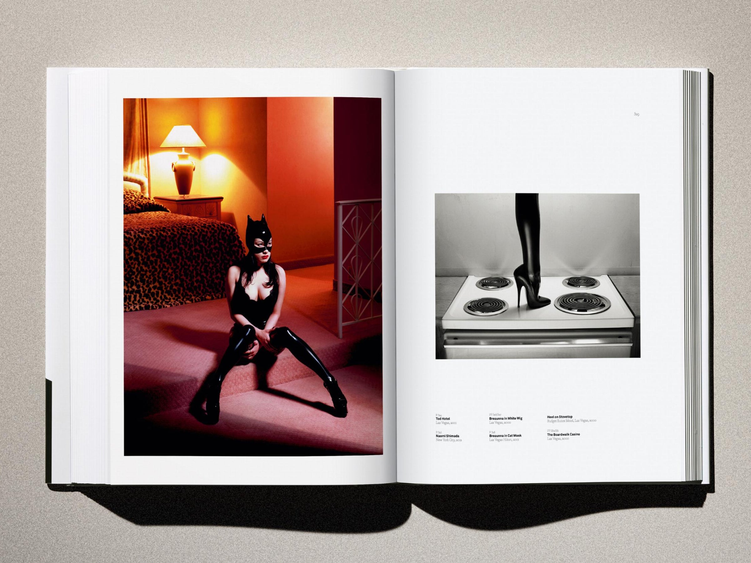 Open Kaos spread: left page shows a woman in a black catsuit and mask posed in a leopard print room, right page shows a high heel on a kitchen stove.